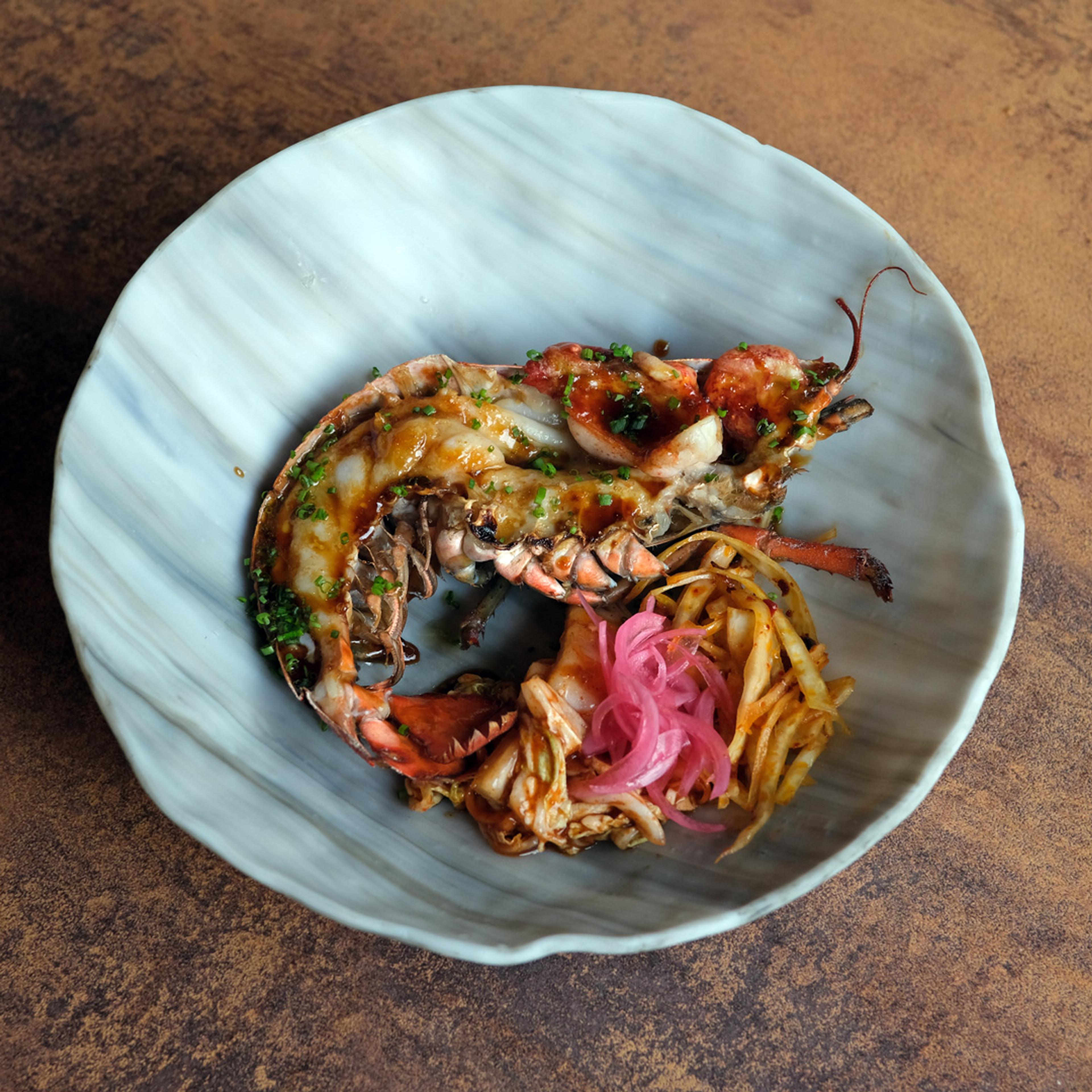 Food from the Michelin-Starred restaurant Sabi Omakase, on a plate.