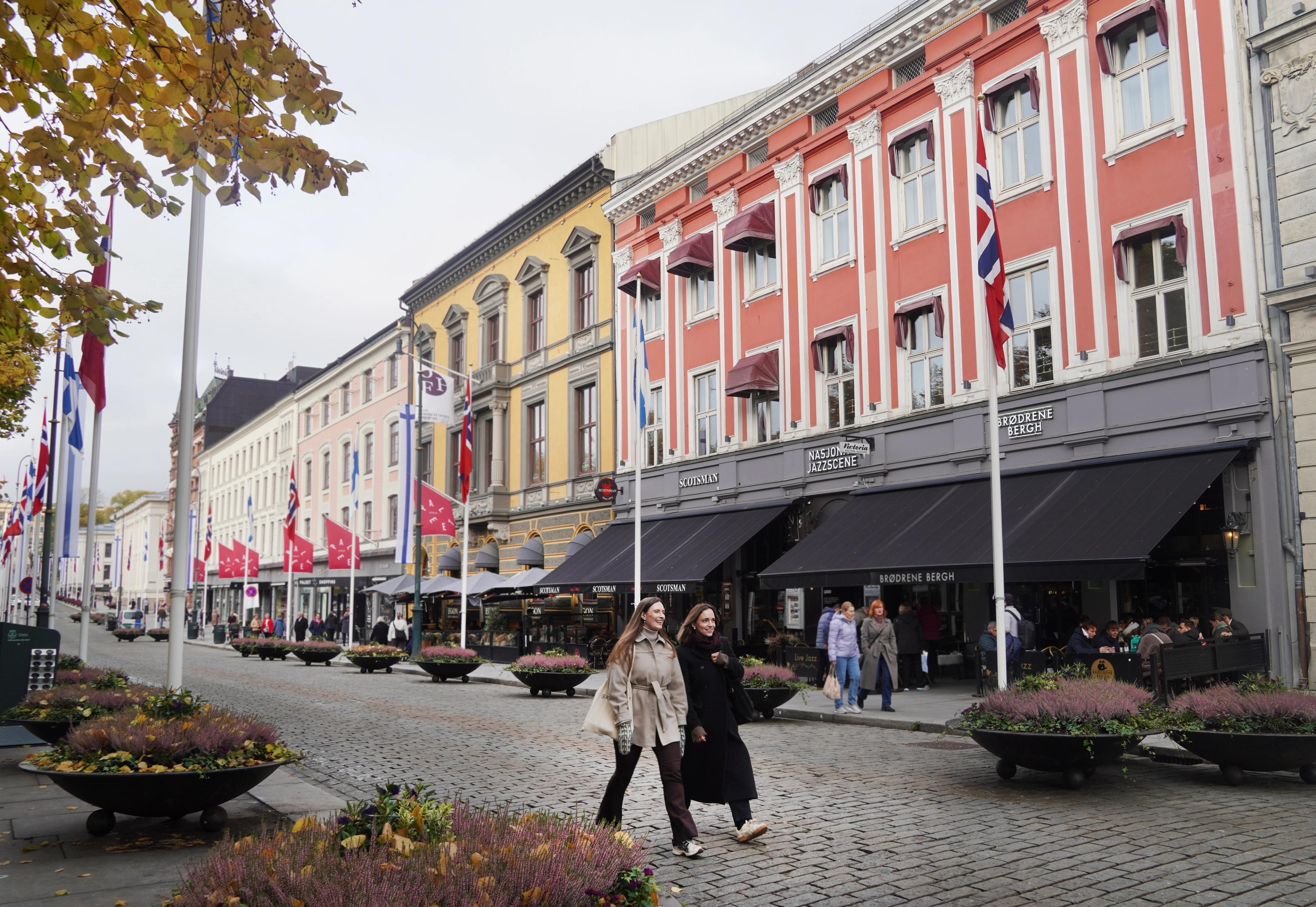 Two woman walking down the main street in Oslo.