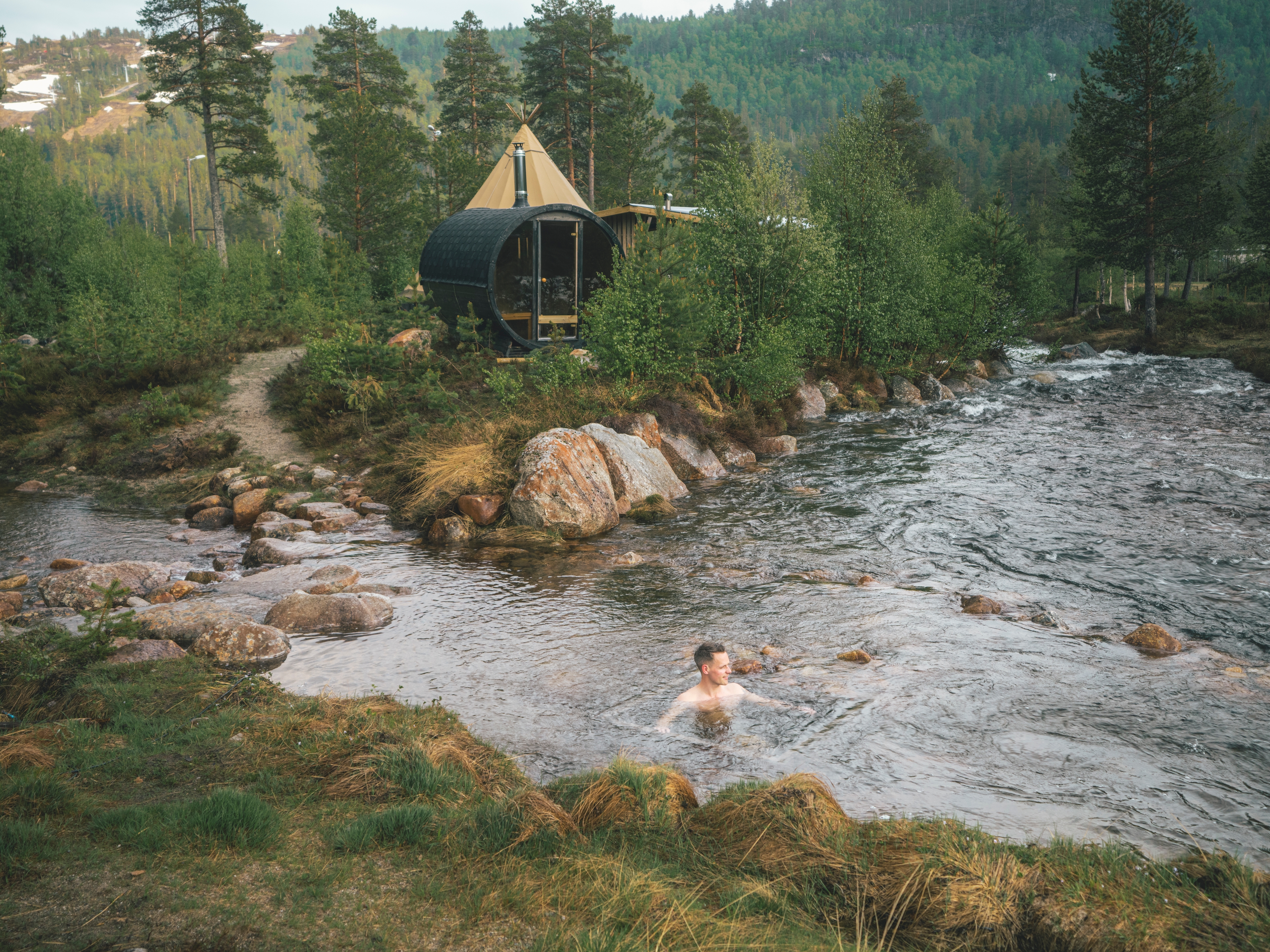 A person taking a dip in the river at Brokkestøylen in Southern Norway