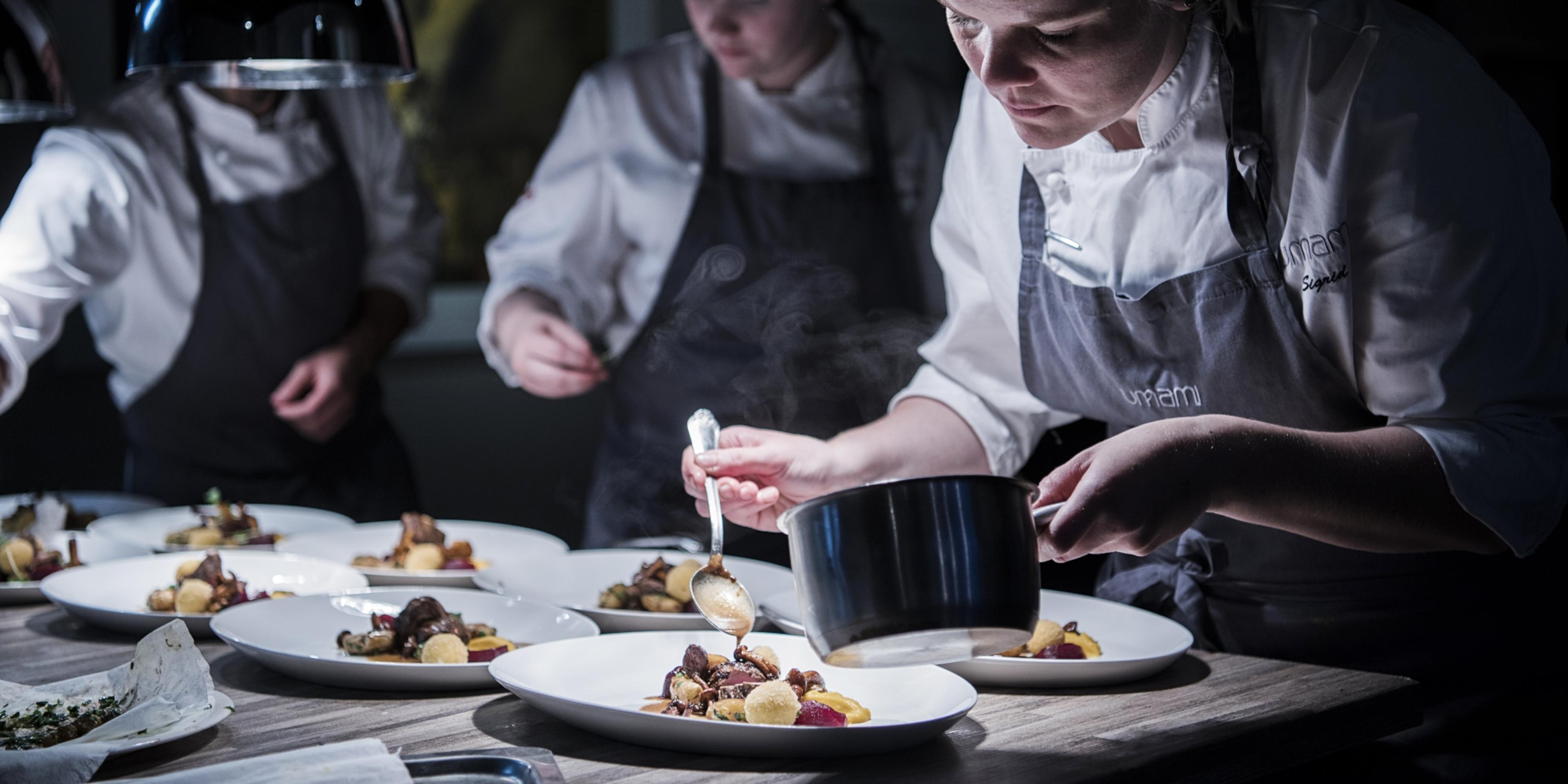 Chefs garnishing raw tastes of autumn in the kitchen at the Umami restaurant in Harstad, Norway