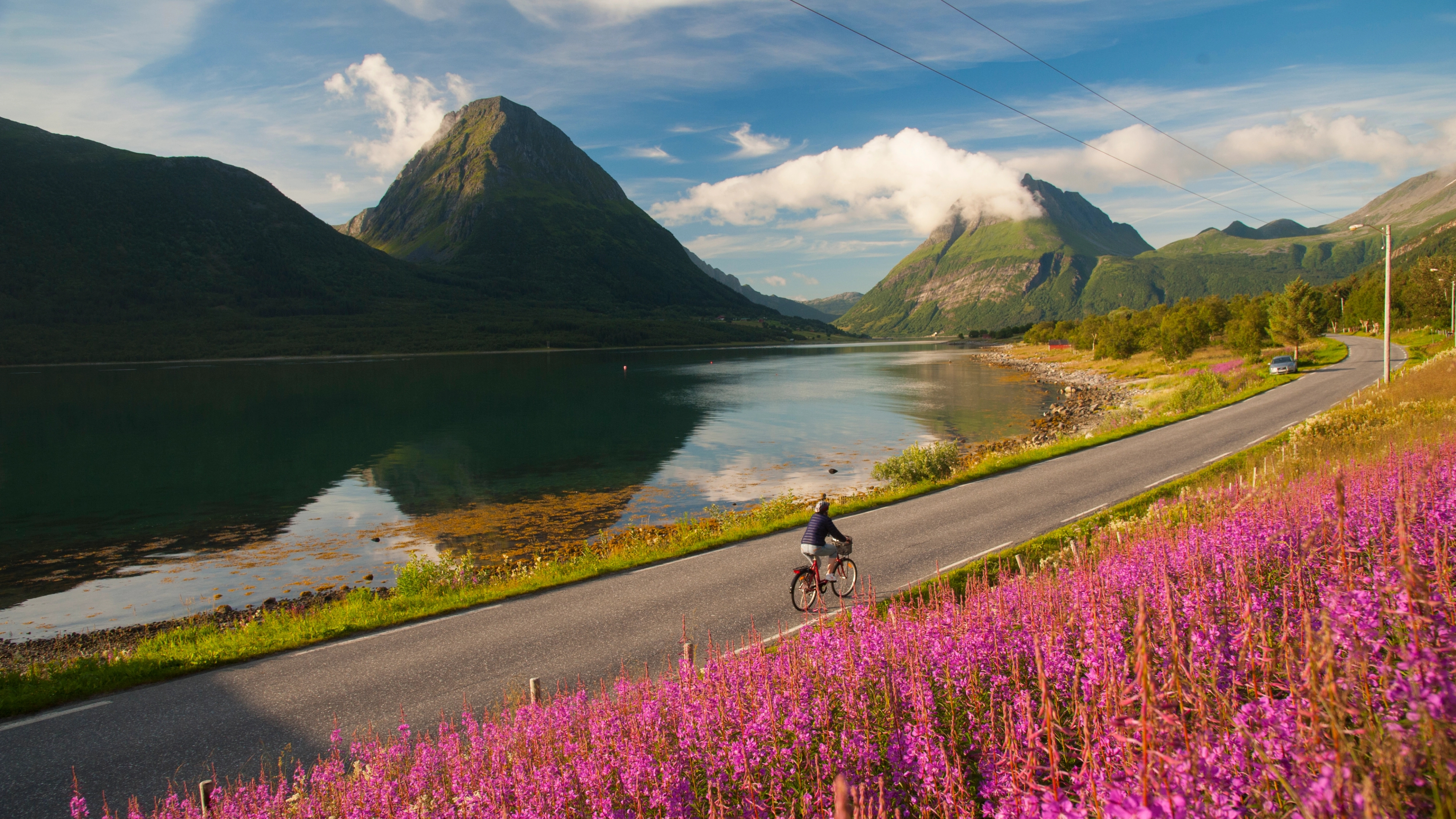 Woman biking in Lurøy, Aldersund