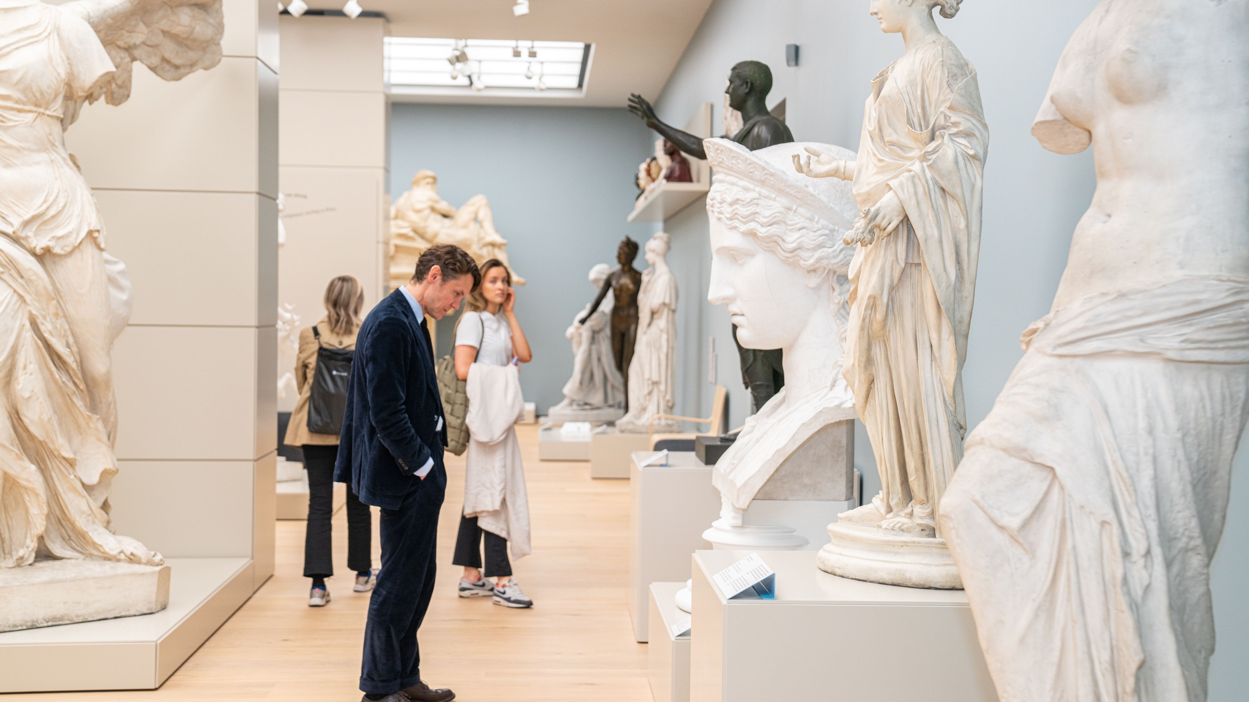 People studying sculptures at The National Museum of Norway