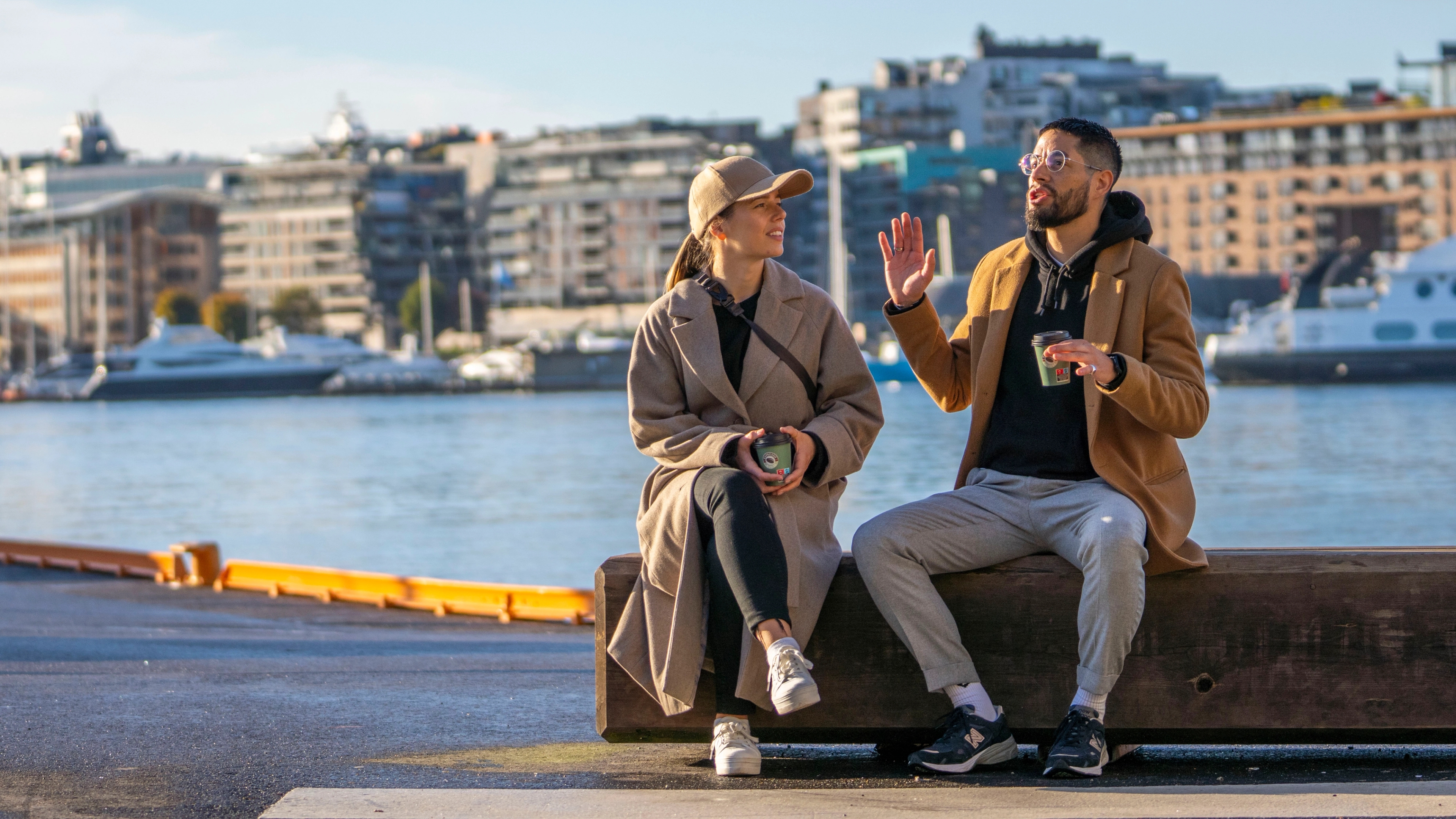 Two friends sitting at Festningskaia in Oslo, Norway