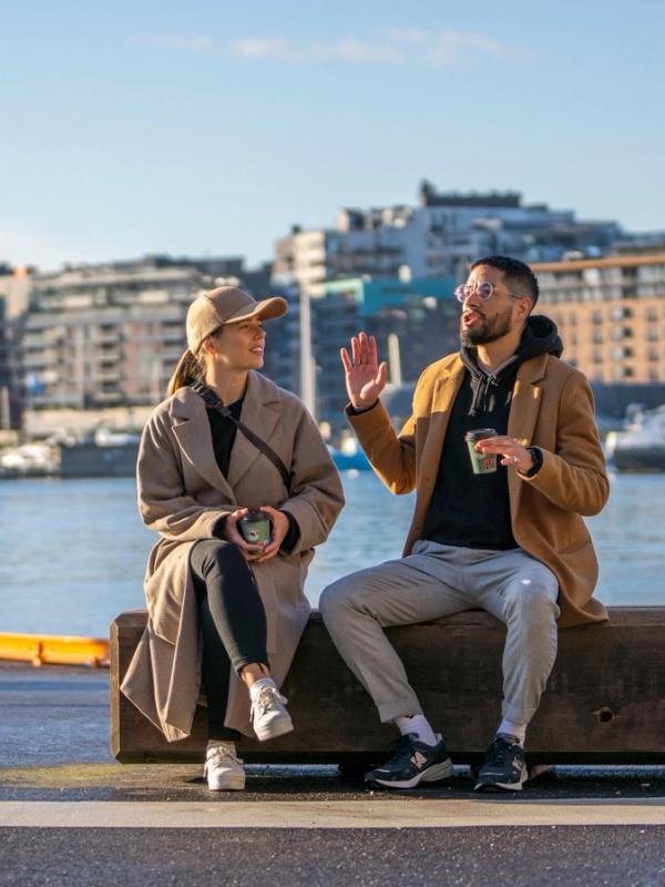 Two friends sitting at Festningskaia in Oslo, Norway