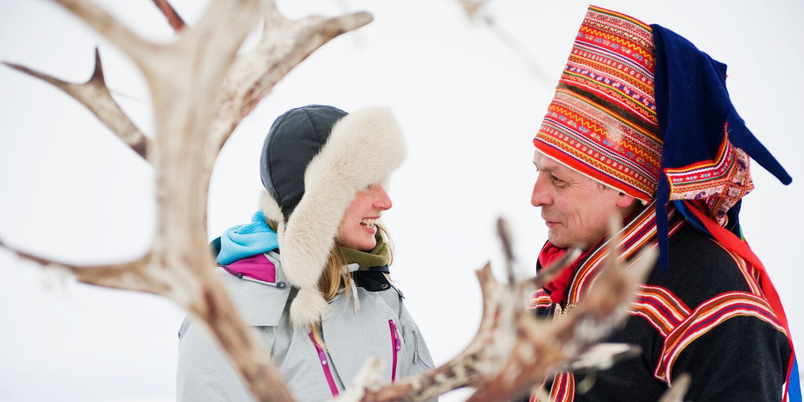 Woman and Sami man with reindeer in Finnmark