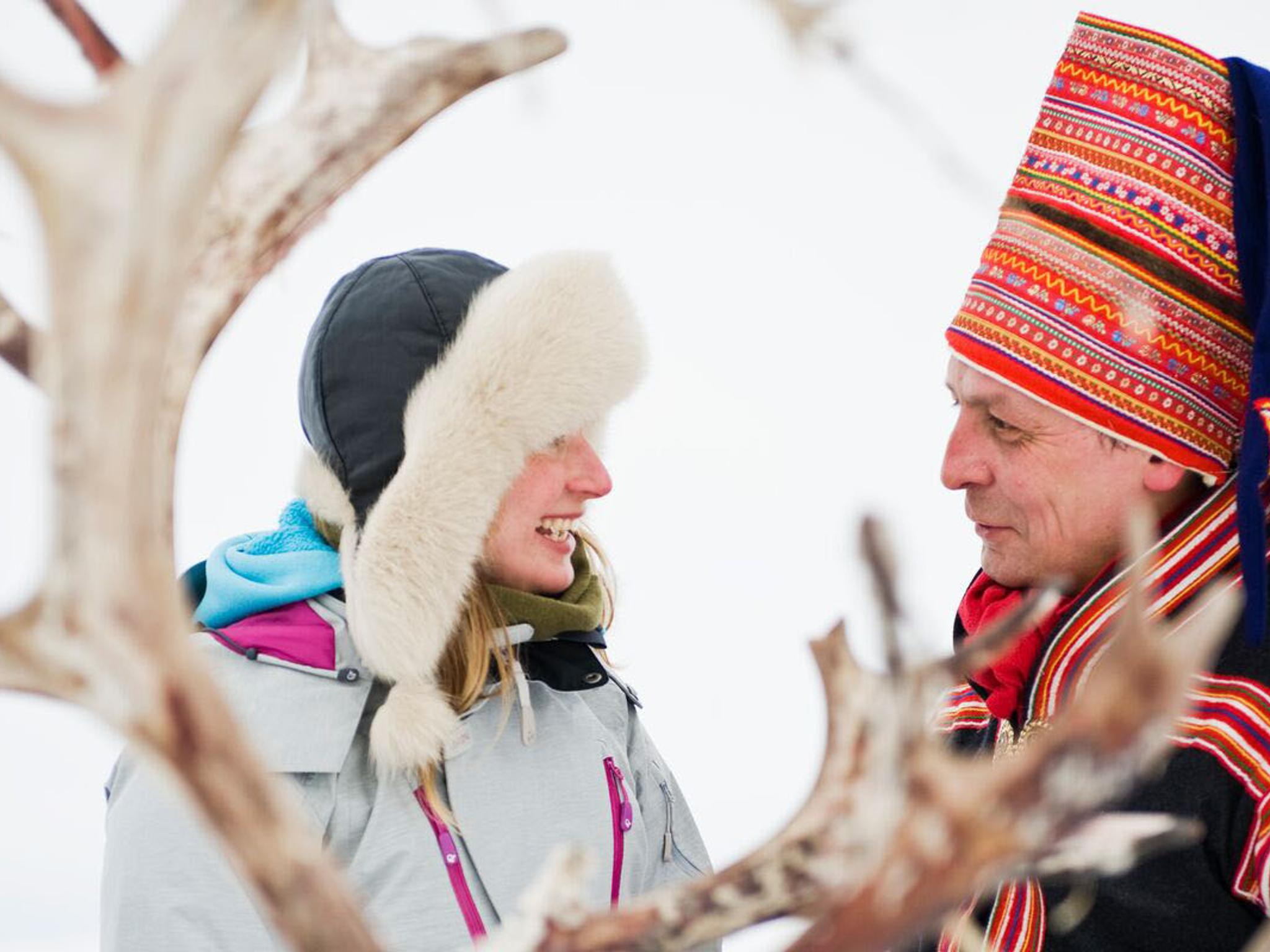 Woman and Sami man with reindeer in Finnmark