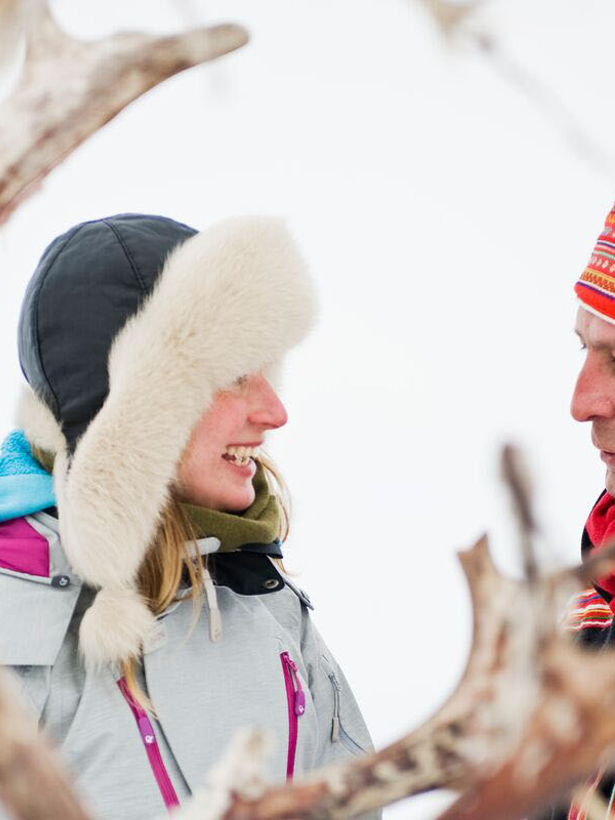 Woman and Sami man with reindeer in Finnmark