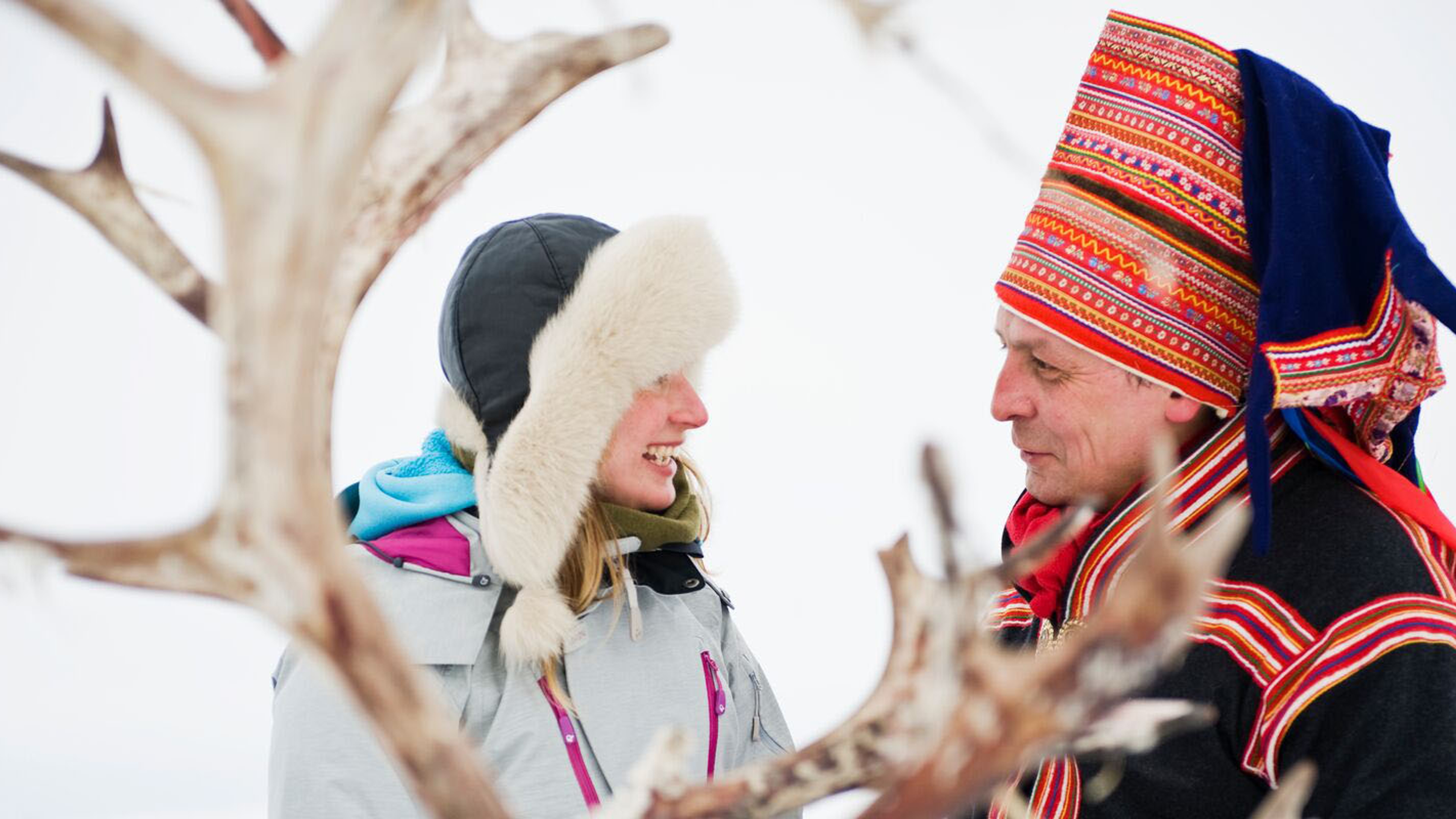 Woman and Sami man with reindeer in Finnmark