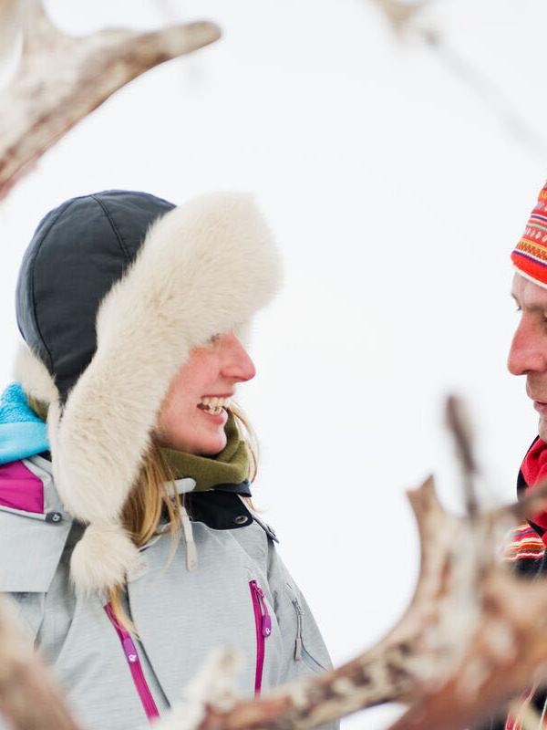 Woman and Sami man with reindeer in Finnmark