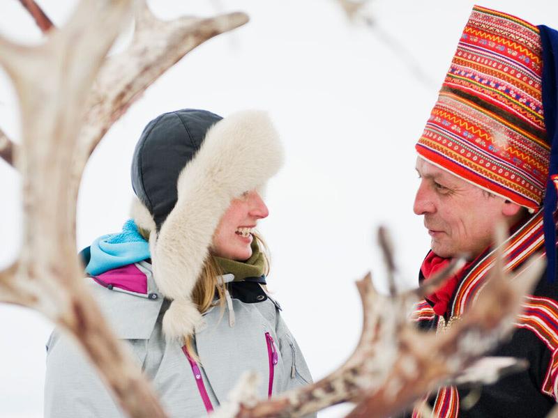 Woman and Sami man with reindeer in Finnmark