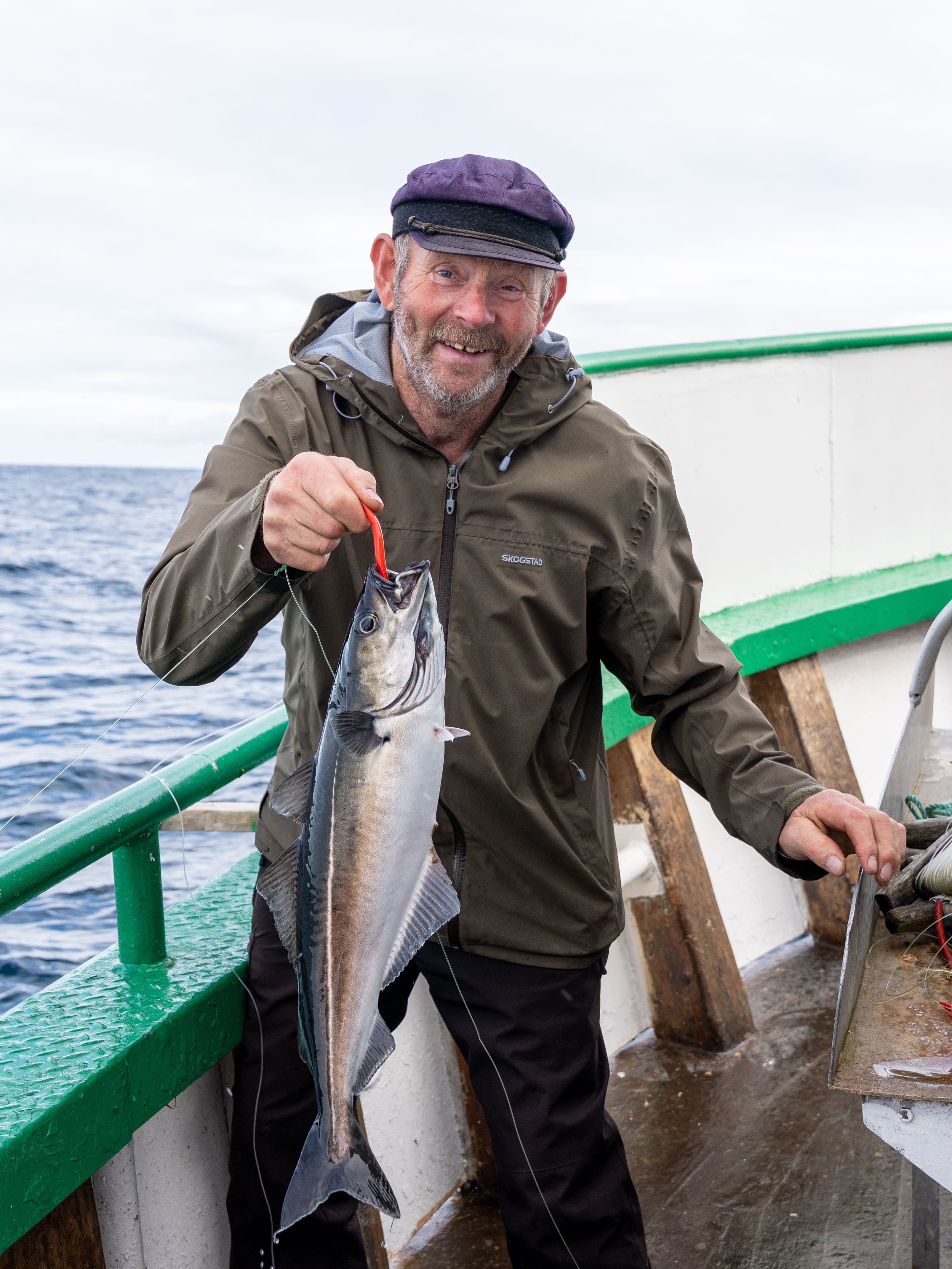 A man holding a fish he just caught