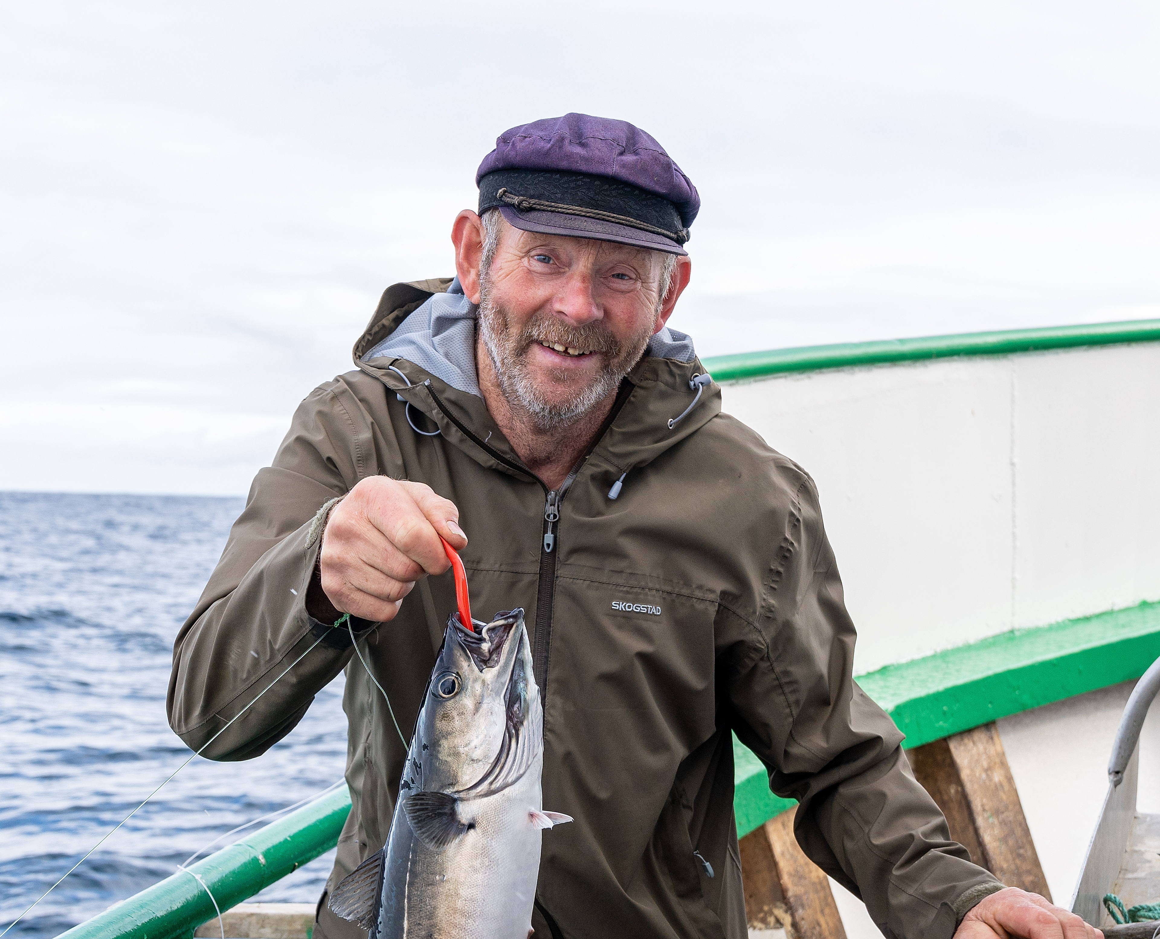 A man holding a fish he just caught
