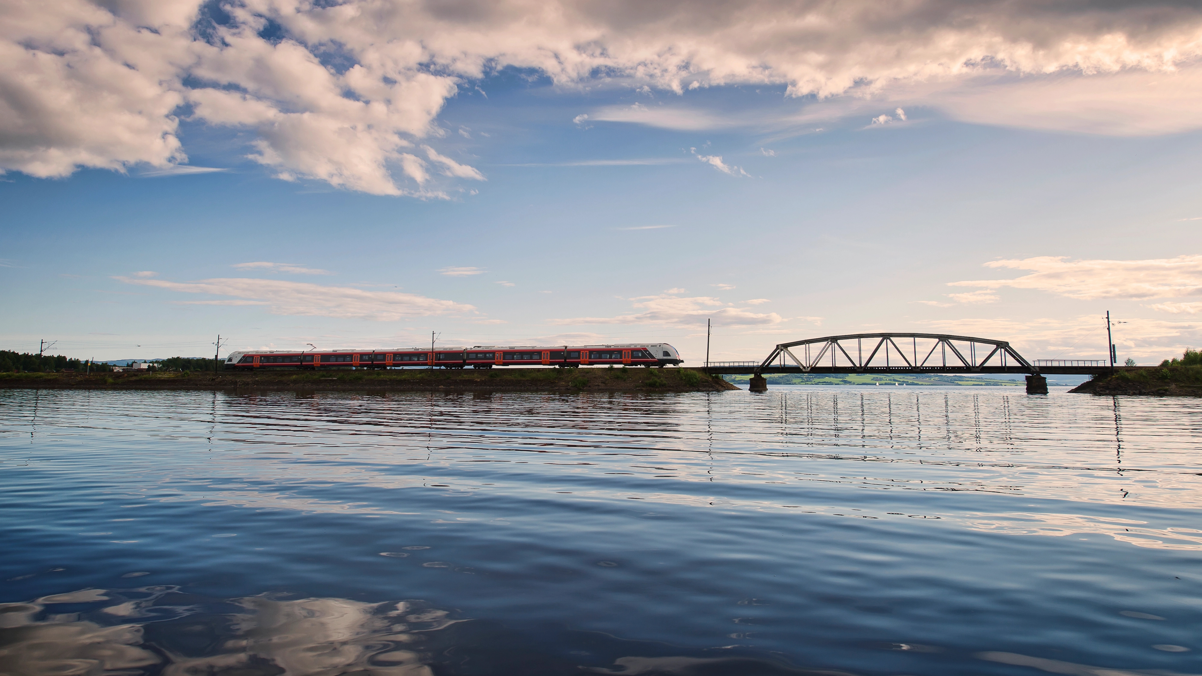 A train on the Sørlandsbanen, crossing a bridge over the water, Southern Norway