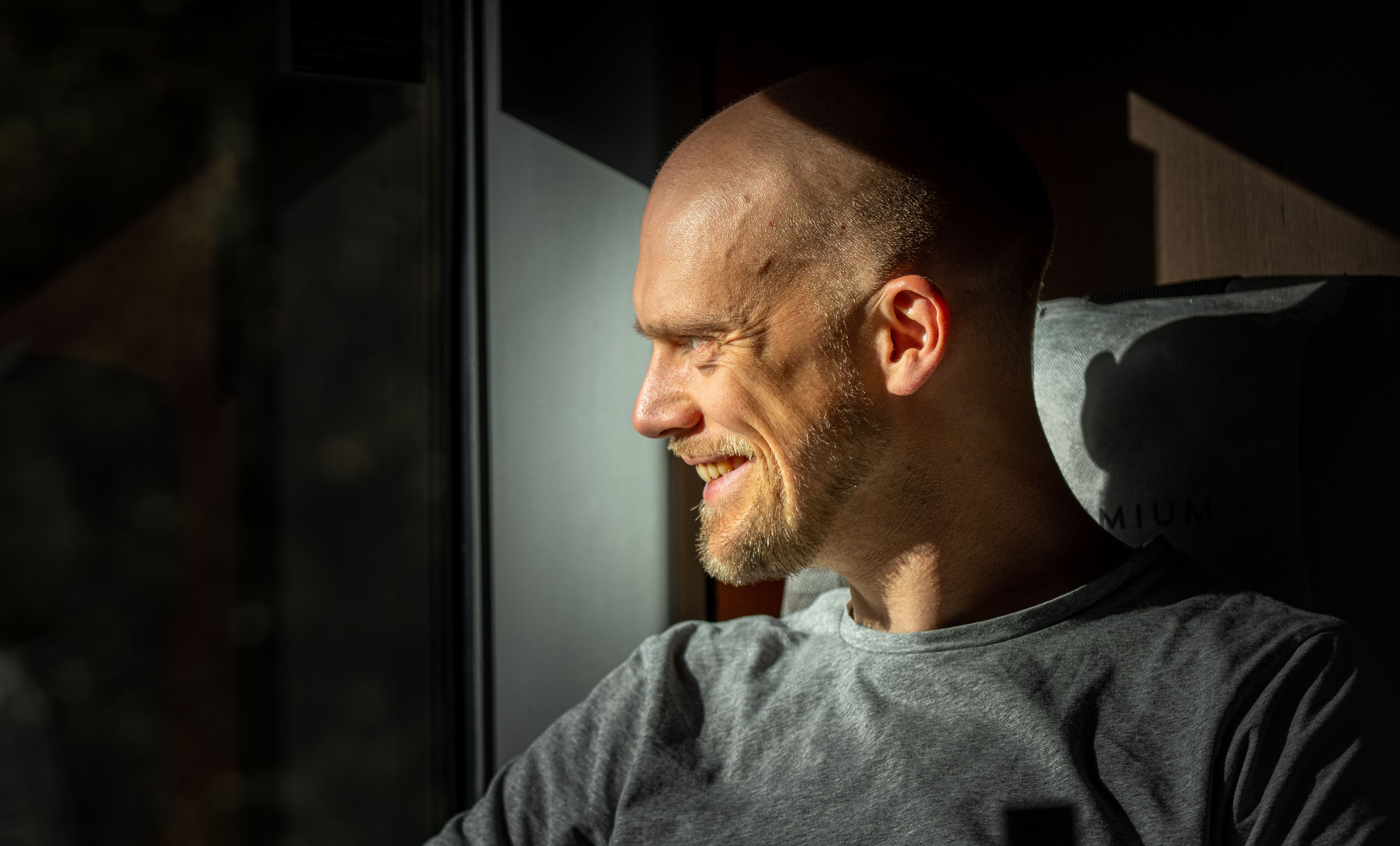 A man sitting in the seat at the Dovre Railway train