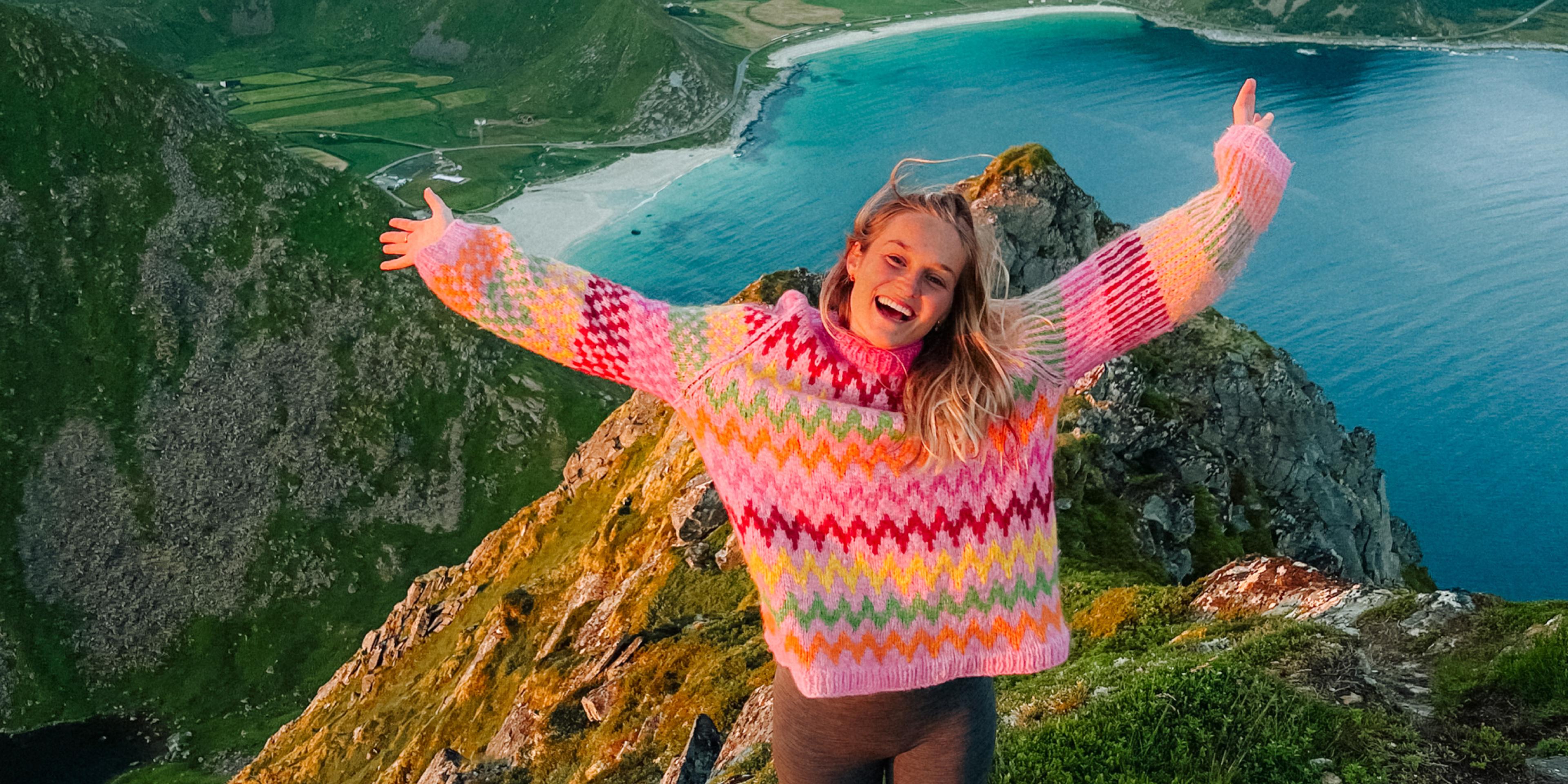 Helene Myhre hiking in a colourful knitted sweater