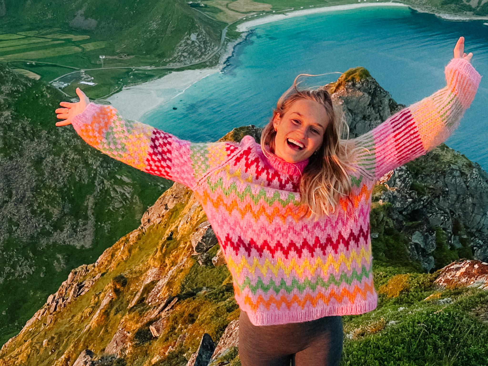Helene Myhre hiking in a colourful knitted sweater