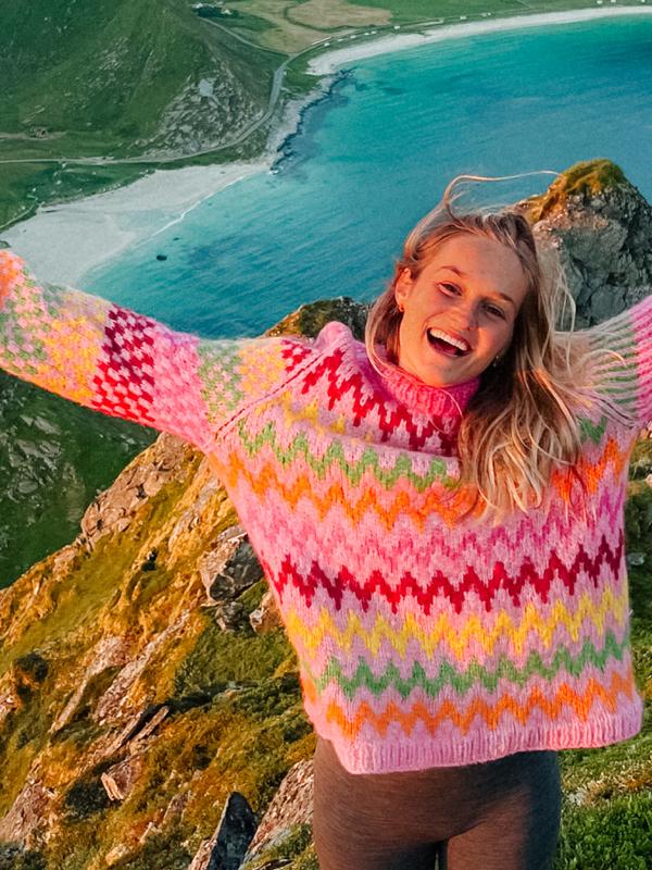 Helene Myhre hiking in a colourful knitted sweater