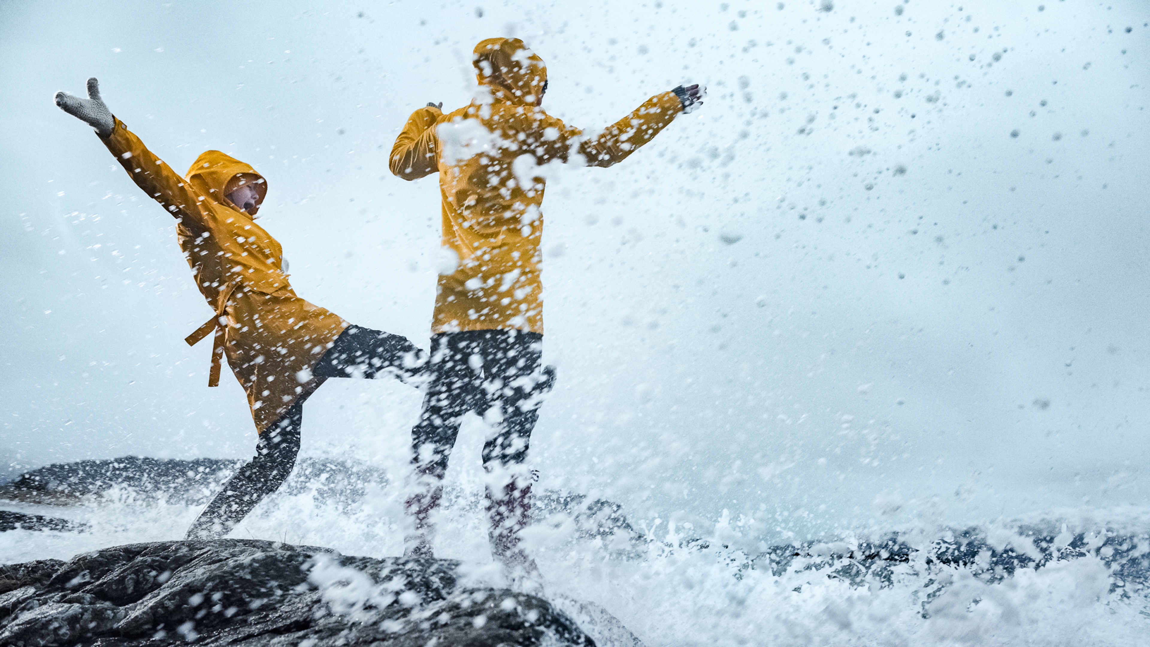 Two people playing in the storm in Kalvåg, Fjord Norway
