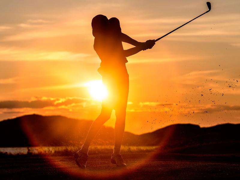 A person playing golf under the midnight sun in Bodø, Norway