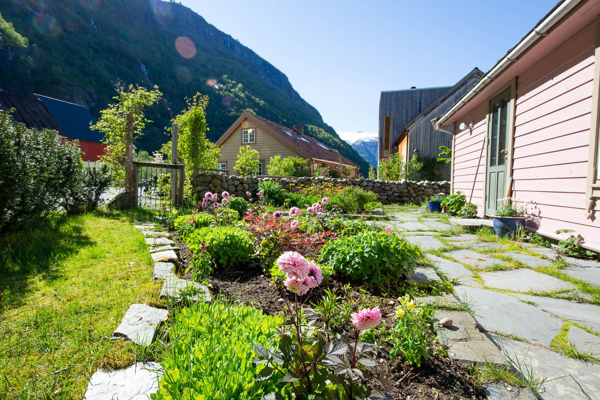 Floral garden surrounded by mountains and little wooden houses
