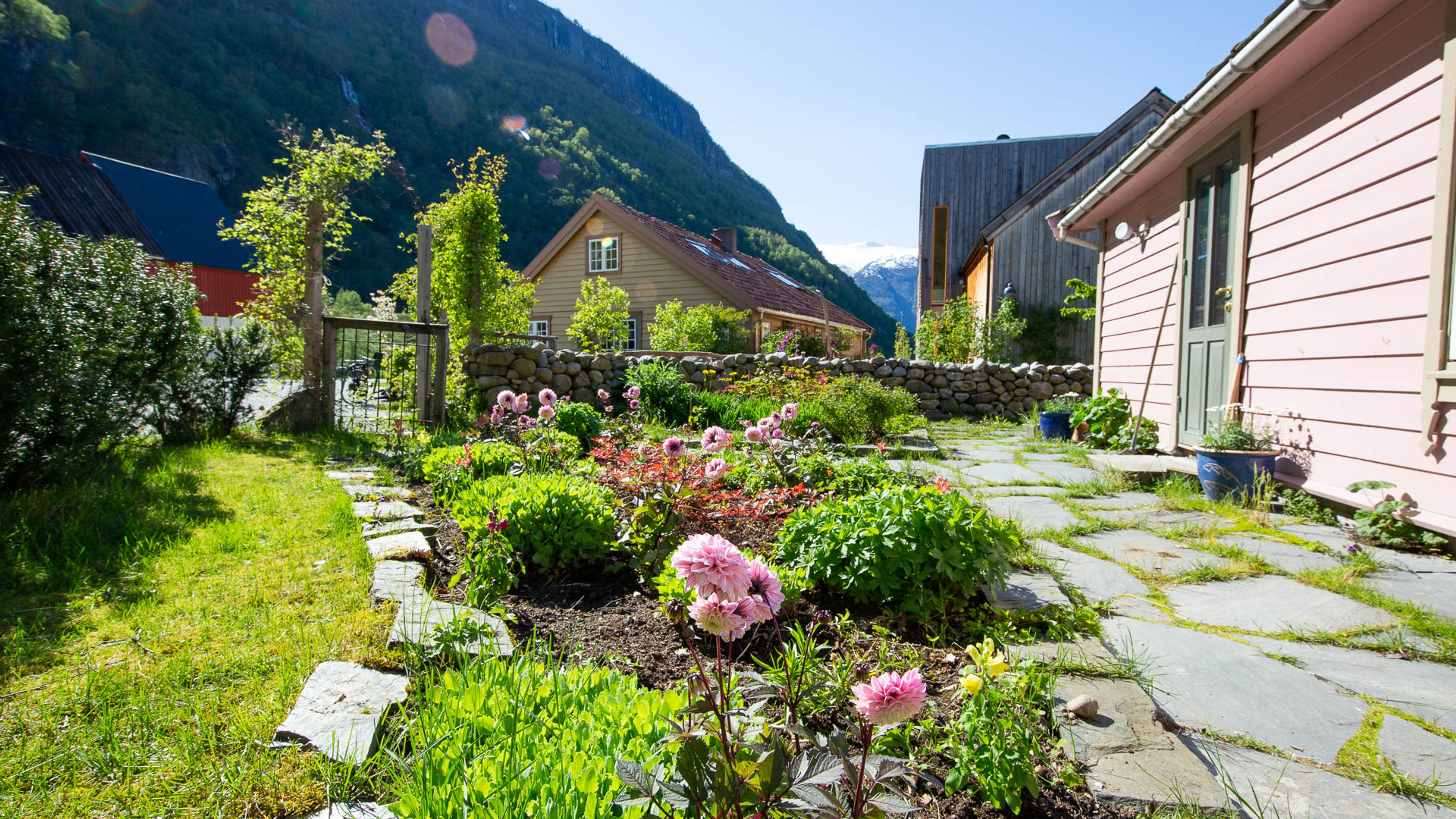 Floral garden surrounded by mountains and little wooden houses
