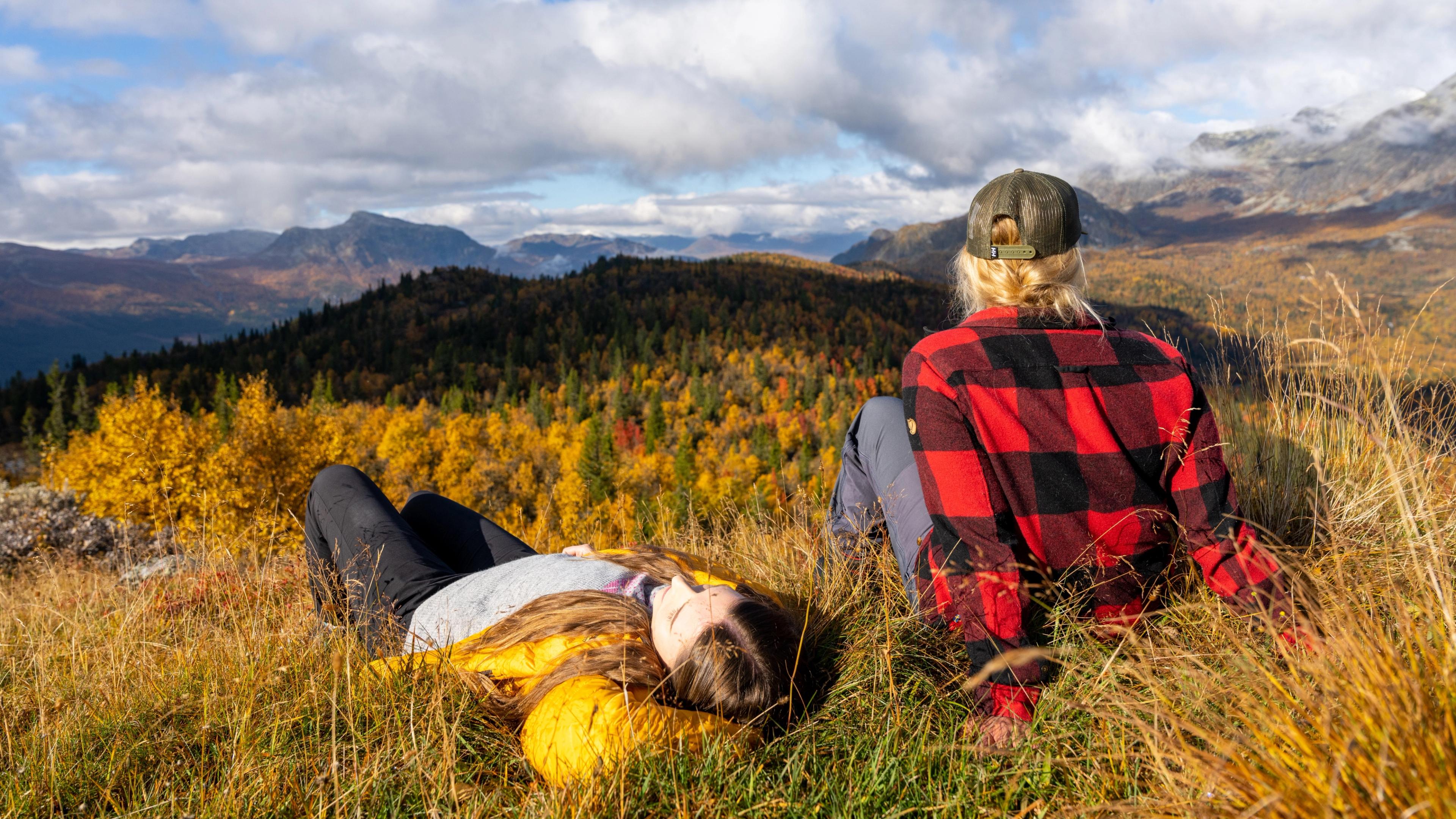Two girls relaxing and enjoying the view of the autumn/fall forest in Hemsedal, Eastern Norway