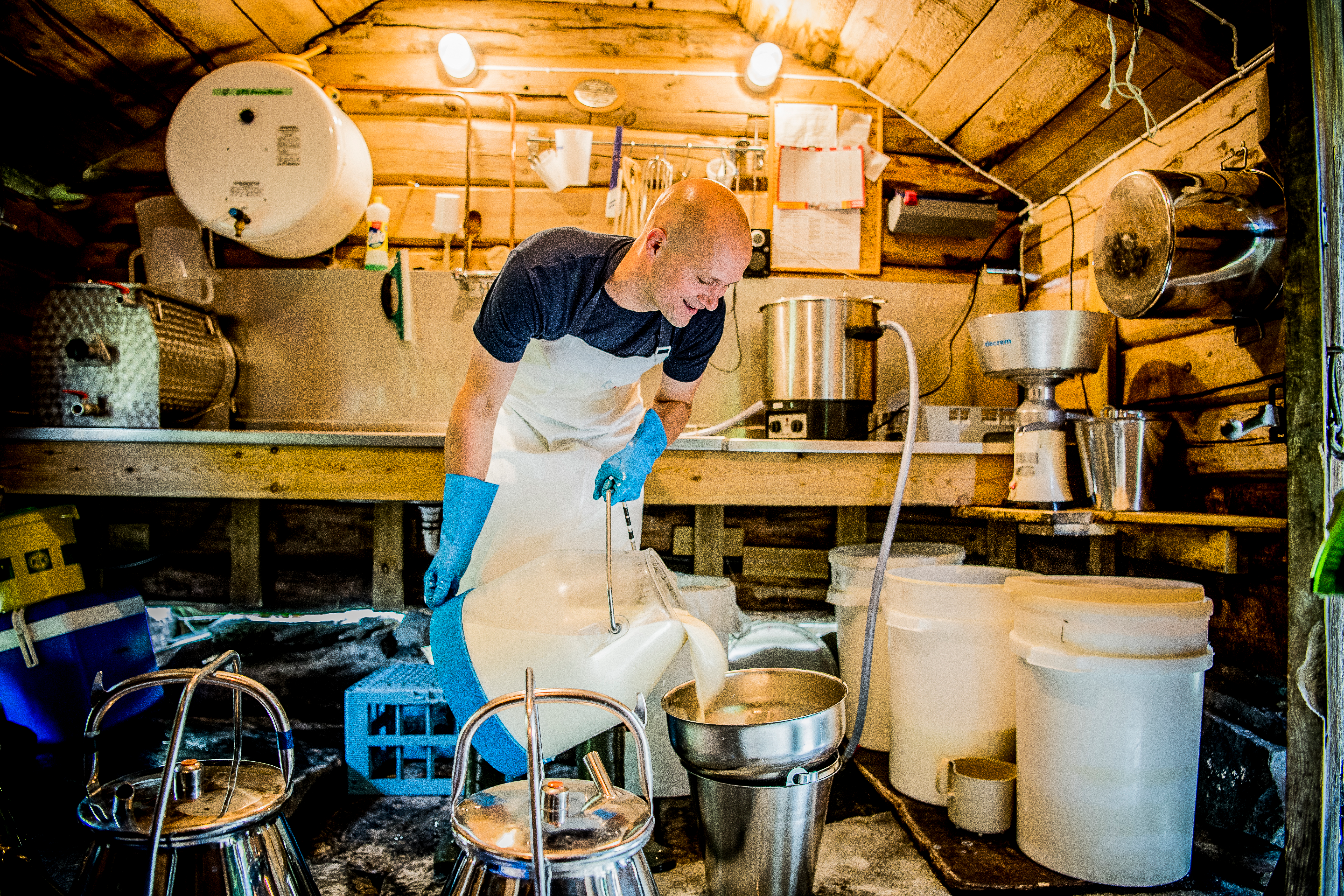 A man processing dairy at the summer mountain farm Renndølsetra in Innerdalen in the northwestern part of Fjord Norway
