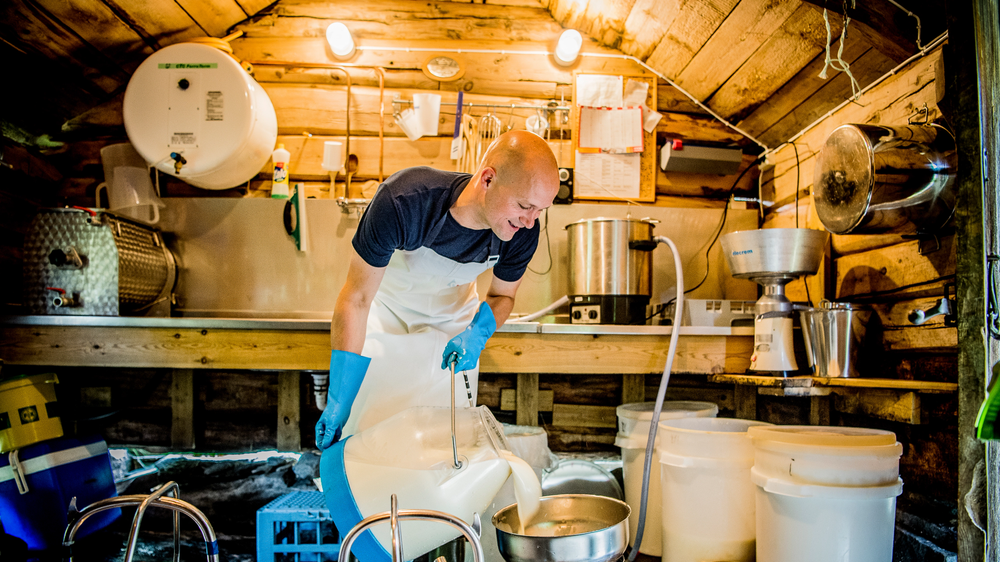A man processing dairy at the summer mountain farm Renndølsetra in Innerdalen in the northwestern part of Fjord Norway