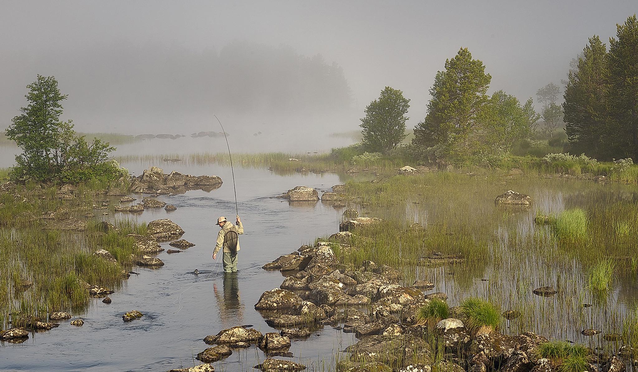 A man fly fishing in a river in Skurdalen in Eastern Norway