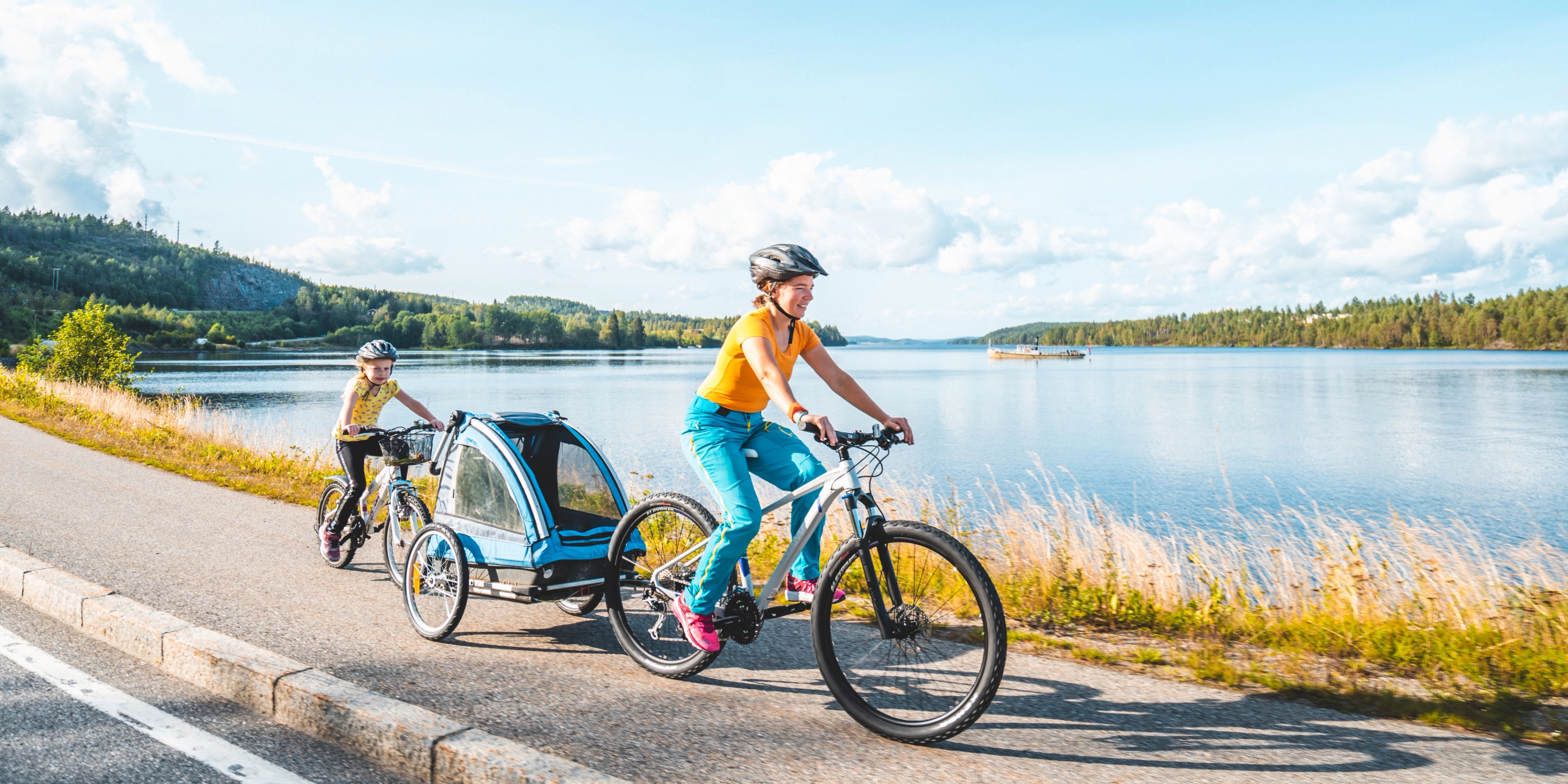 People cycling along the lake in Inner Østfold, Eastern Norway