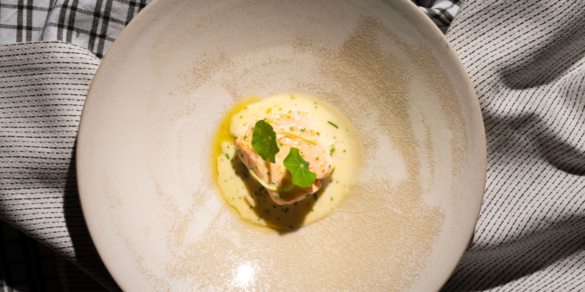 A plate with traditional baked salmon with Sandefjord butter made by star chef Tom Victor Gausdal.