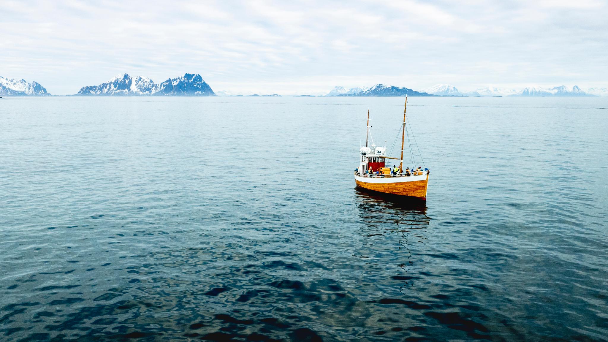 an old fishingboat out at sea in Lofoten