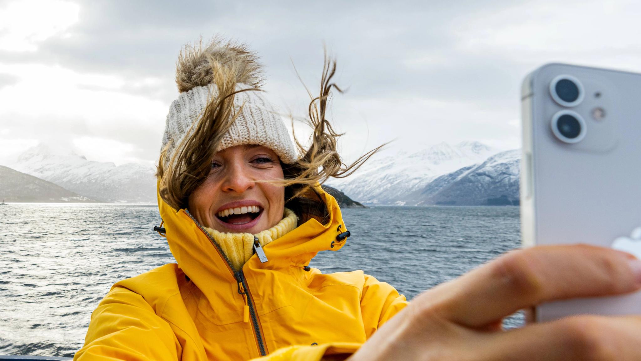 Woman taking a selfie on a winter cruise on the Geirangerfjord