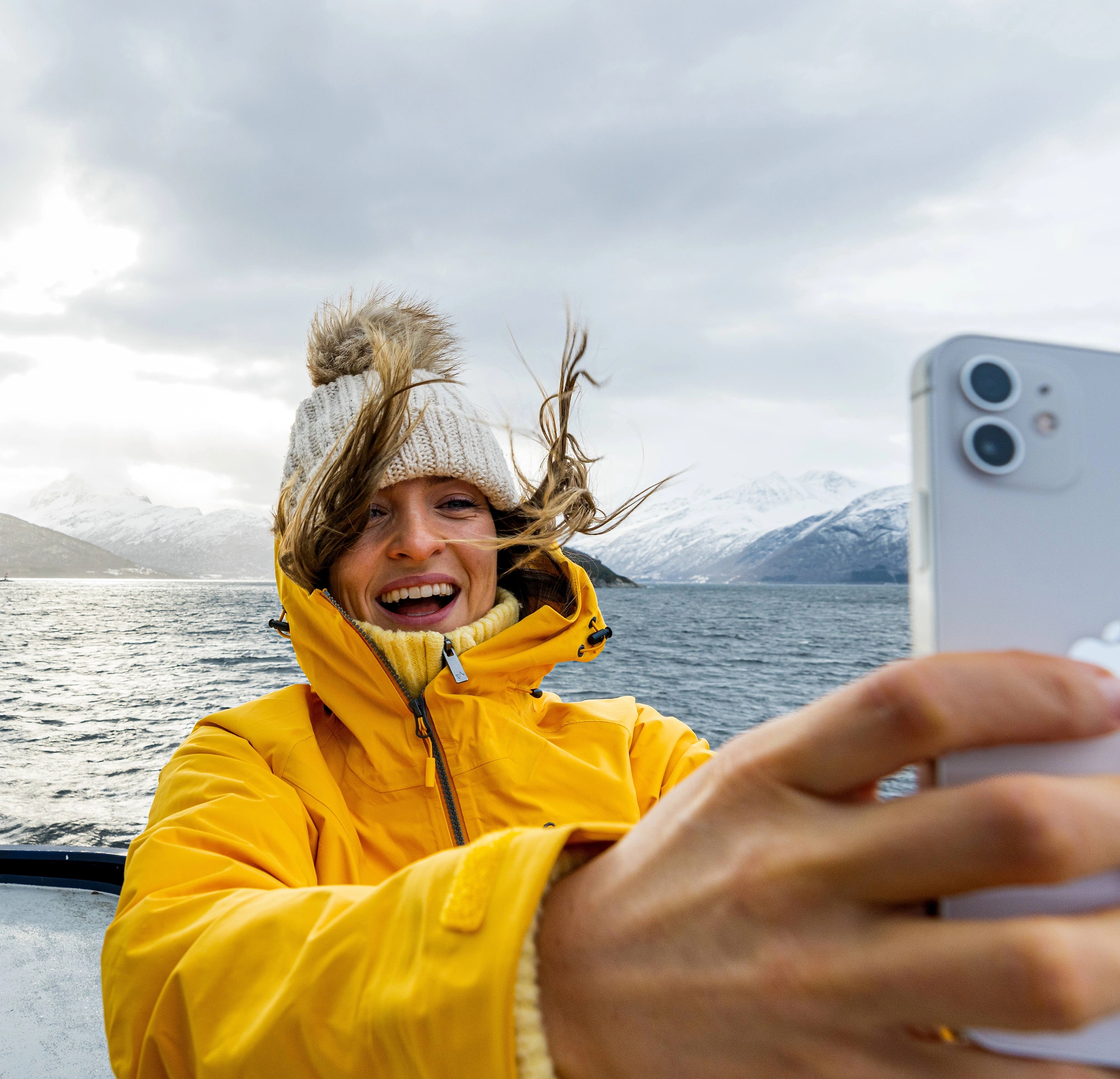 Woman taking a selfie on a winter cruise on the Geirangerfjord