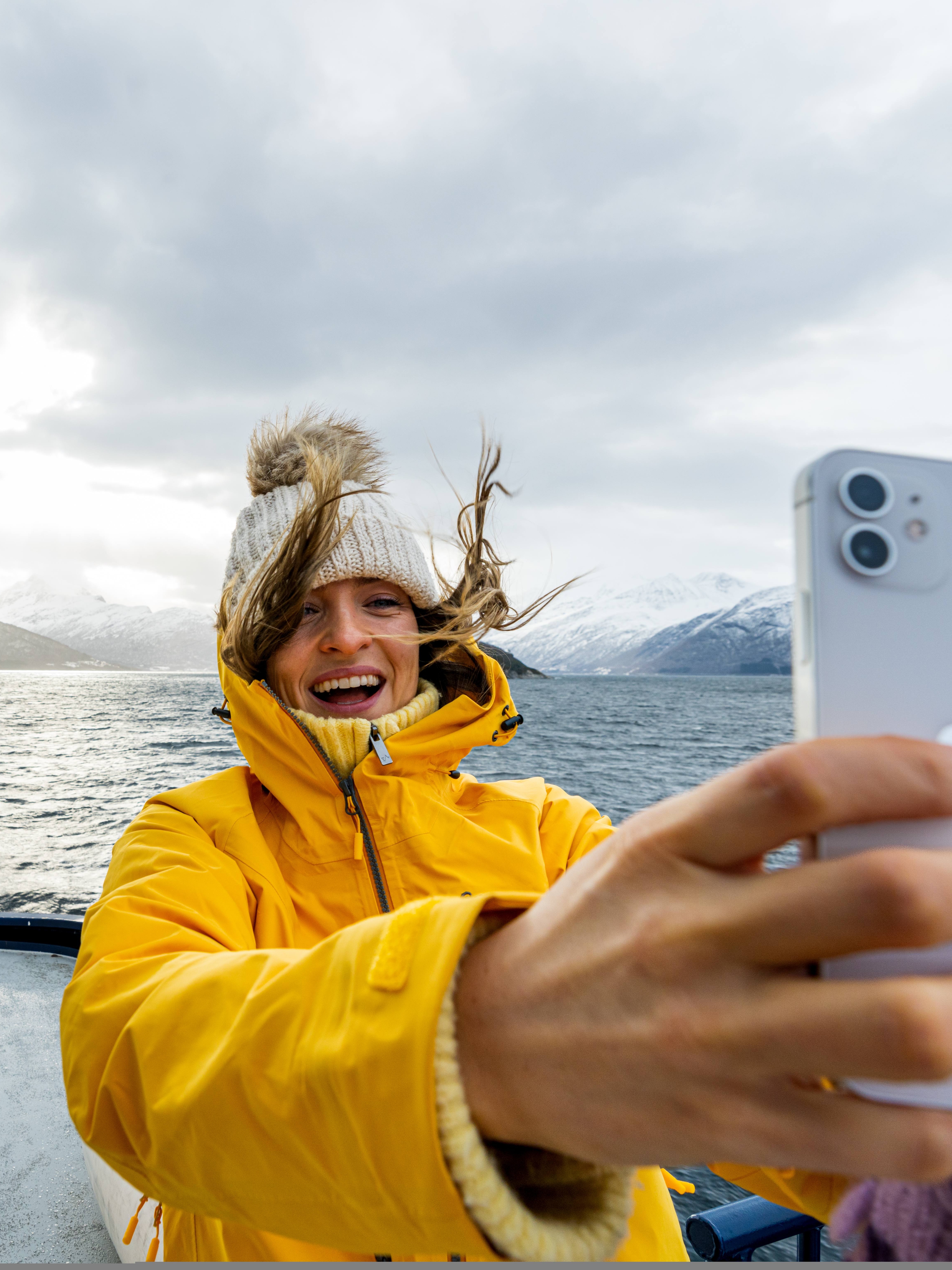 Woman taking a selfie on a winter cruise on the Geirangerfjord