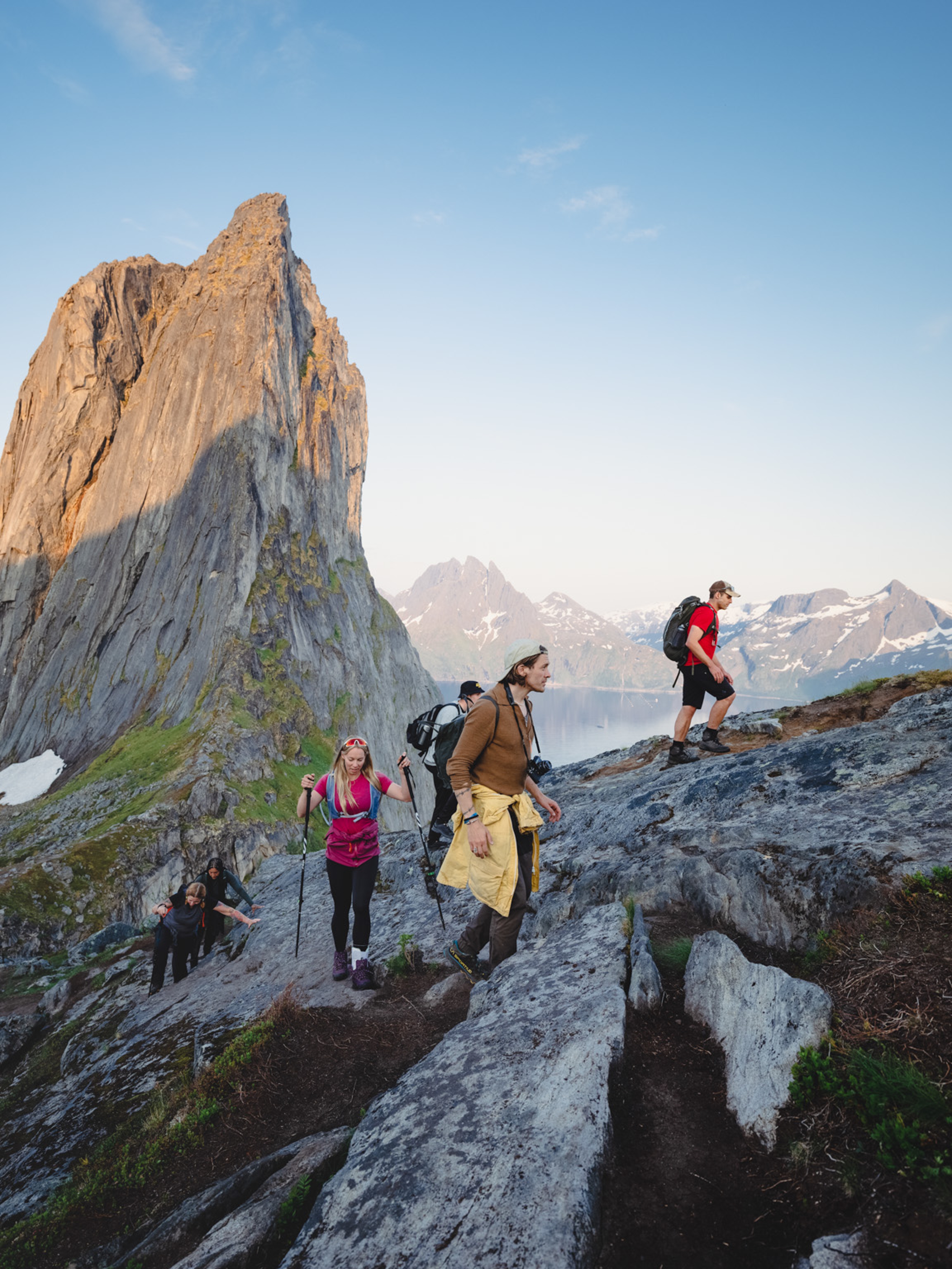 People hiking up a steep mountain with beautiful views.