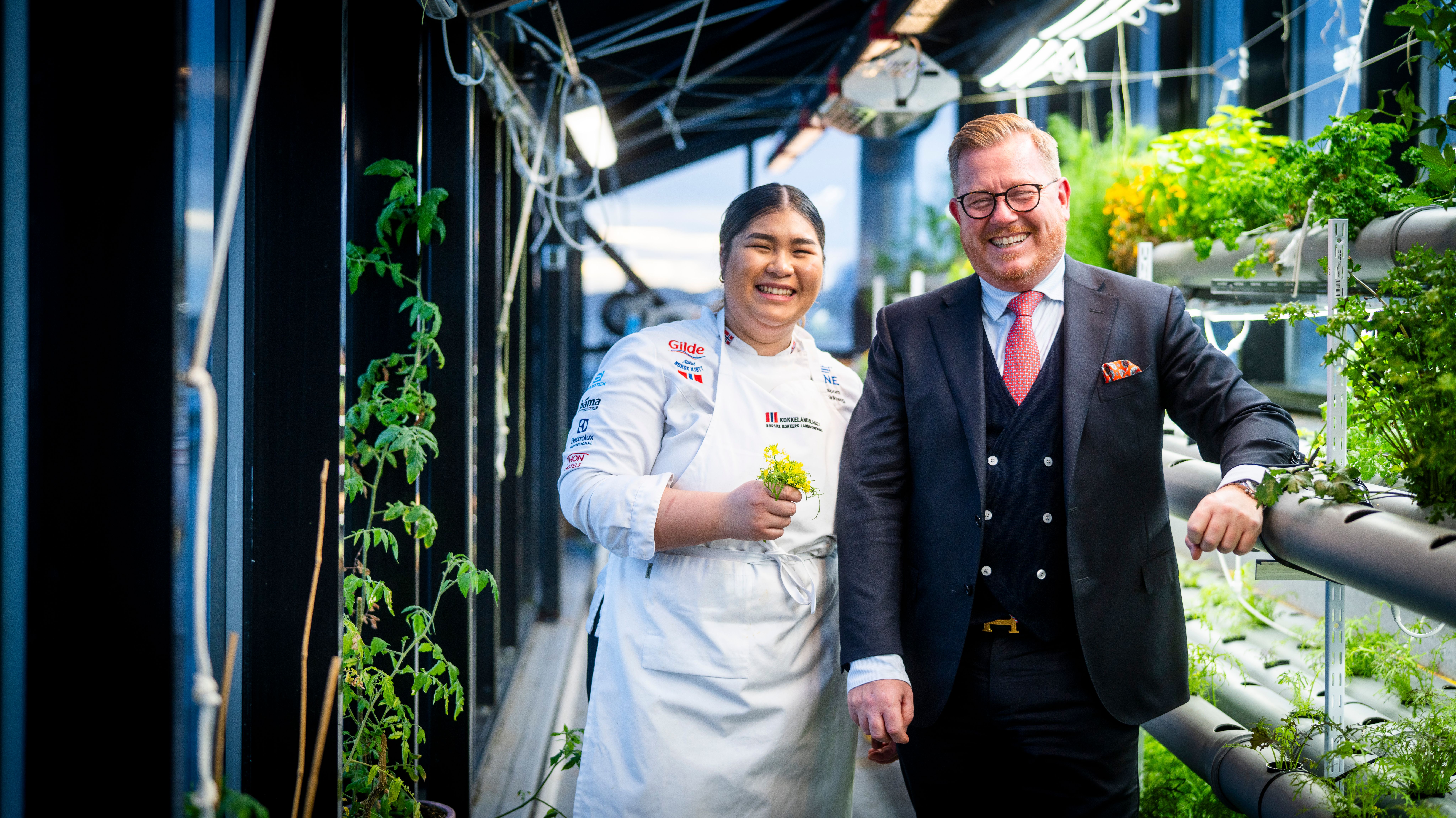 Two people in a greeenhouse