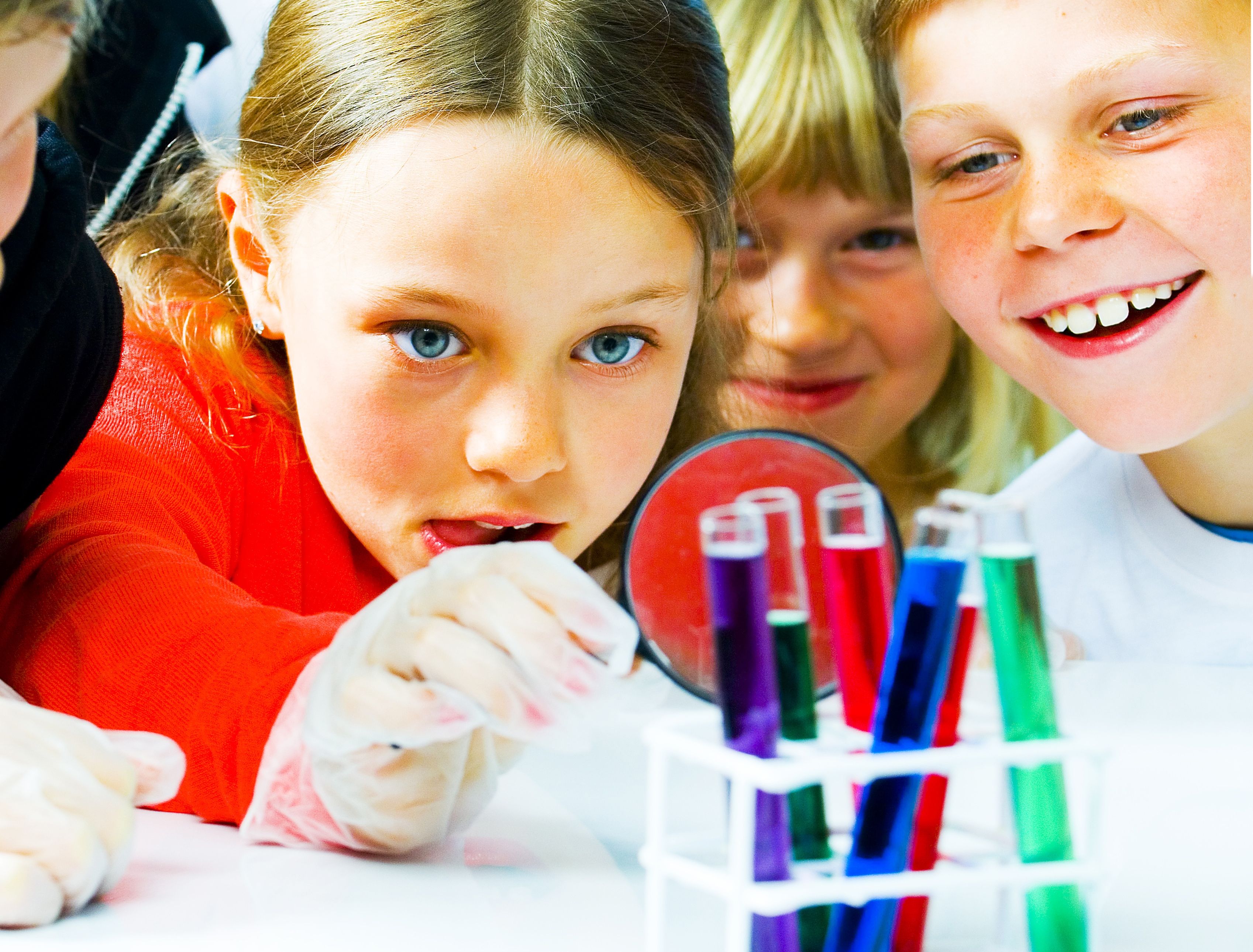 Kids experimenting with colourful vials at The science center in Arendal, Southern Norway