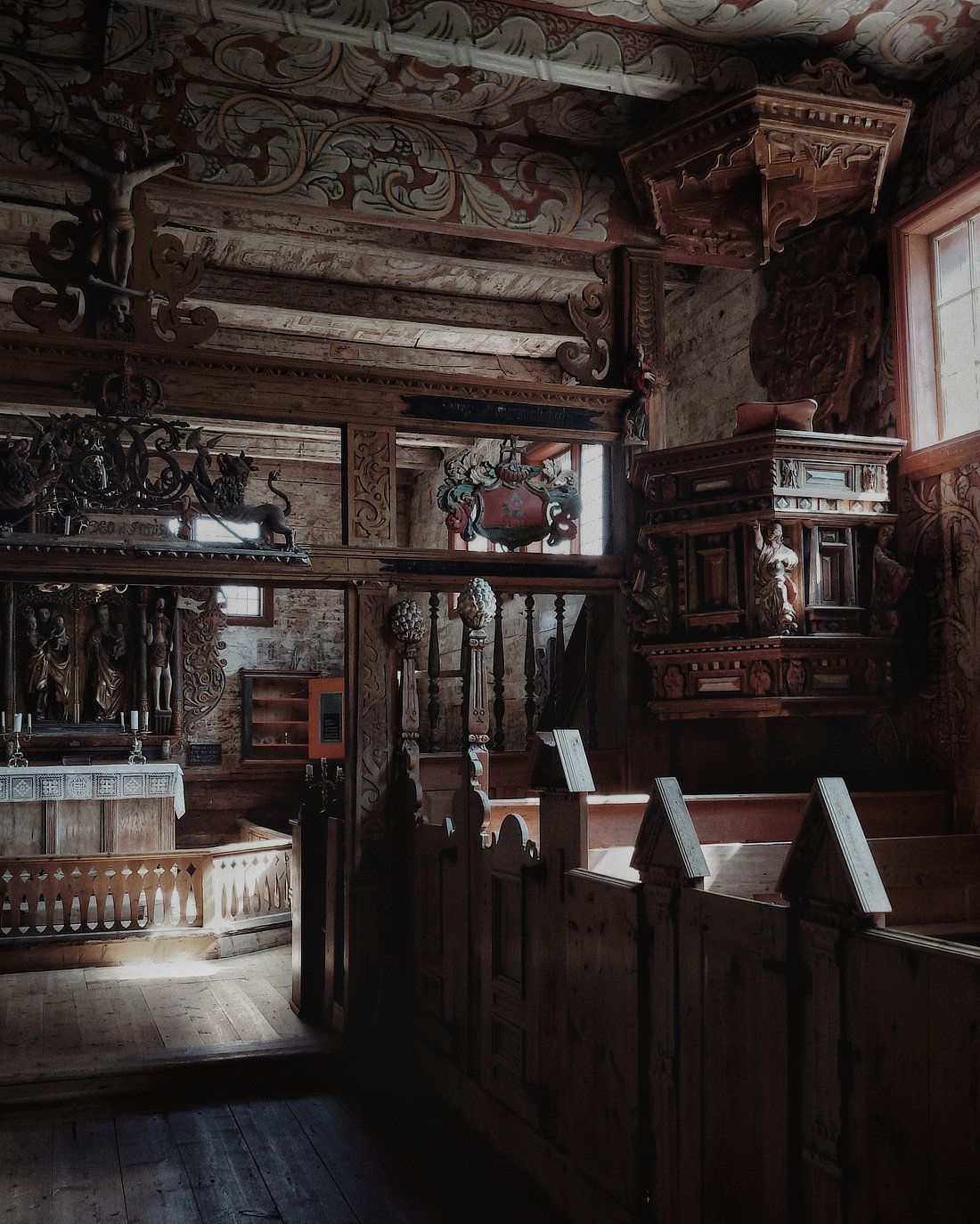 Inside the Kvernes stave church you can see elaborate carvings and paintings