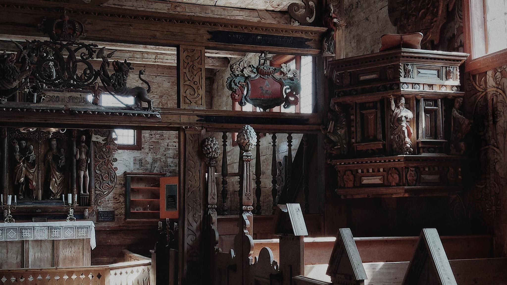 Inside the Kvernes stave church you can see elaborate carvings and paintings