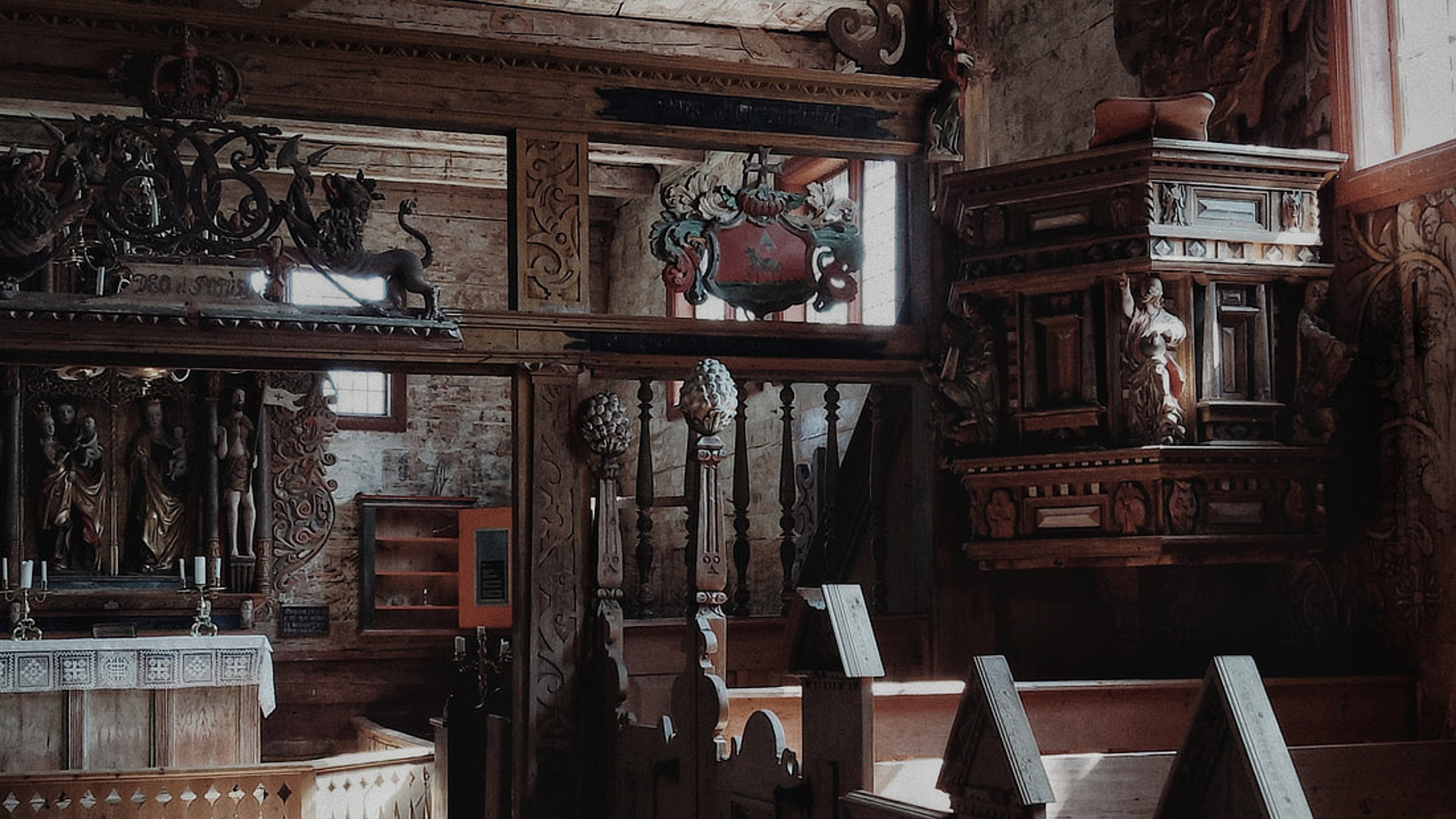Inside the Kvernes stave church you can see elaborate carvings and paintings