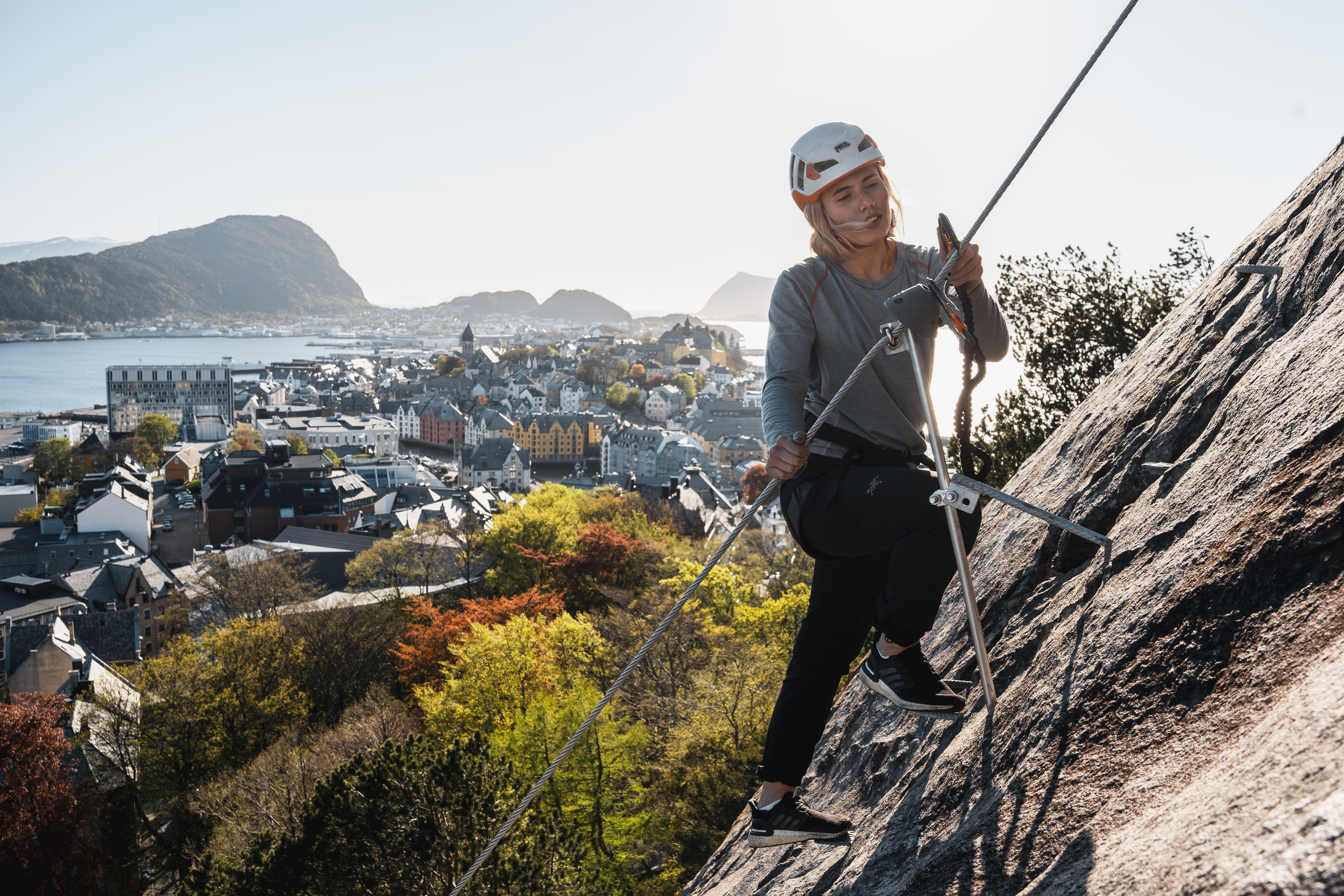 Woman climbing the Via Ferrata in the city centre of Ålesund in Fjord Norway