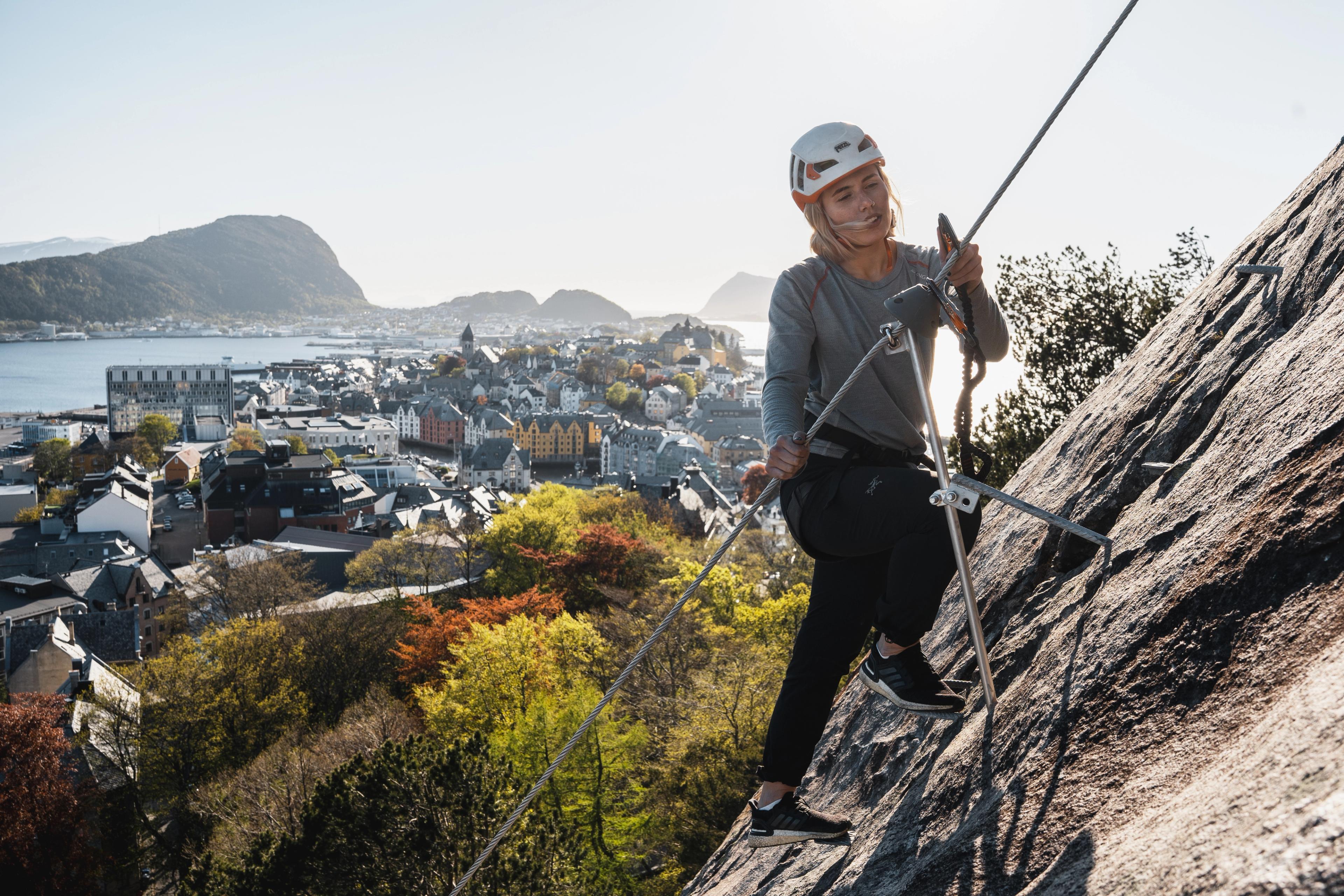 Woman climbing the Via Ferrata in the city centre of Ålesund in Fjord Norway