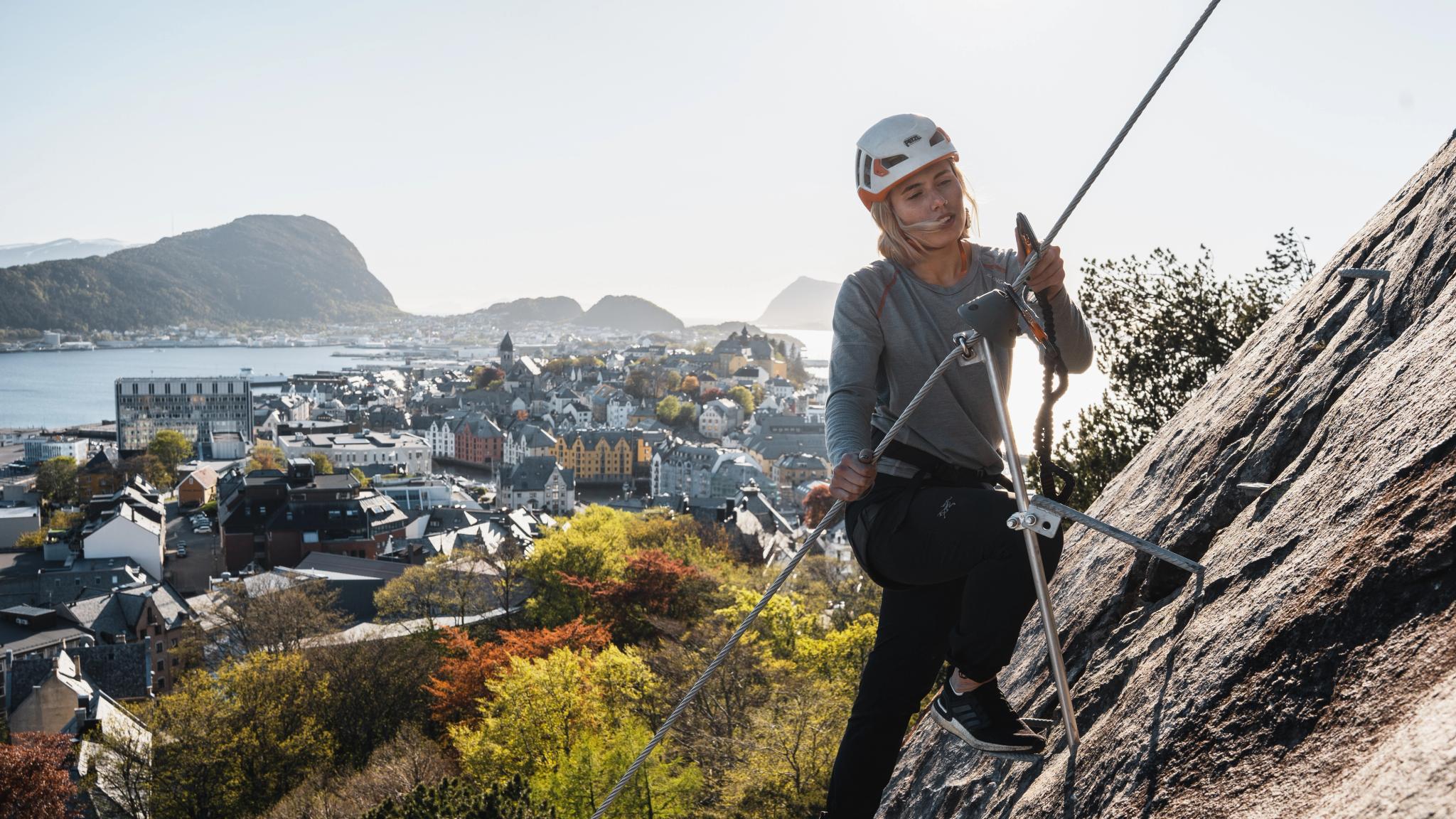 Woman climbing the Via Ferrata in the city centre of Ålesund in Fjord Norway