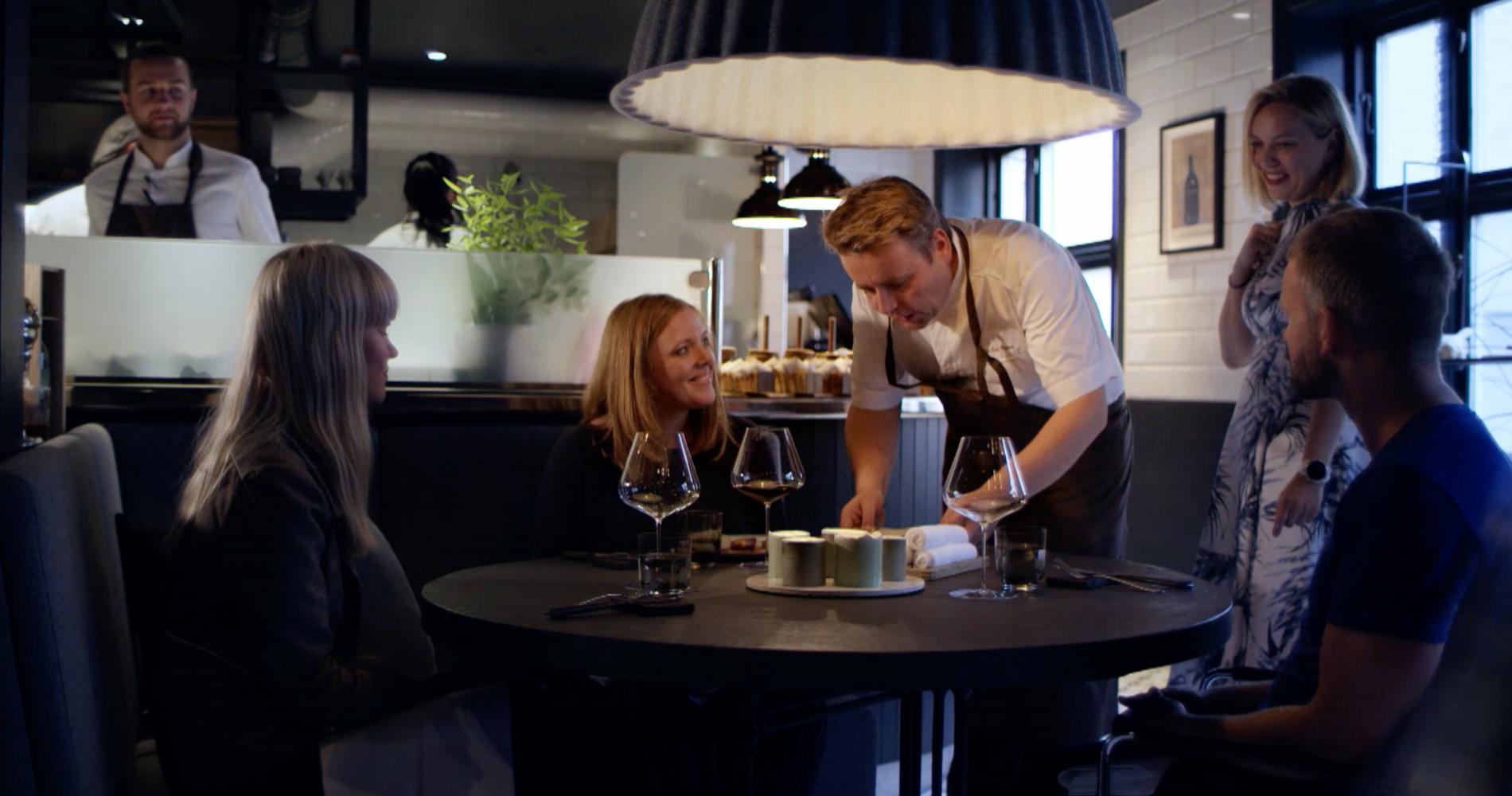 Chef serving a meal at Re-Naa restaurant