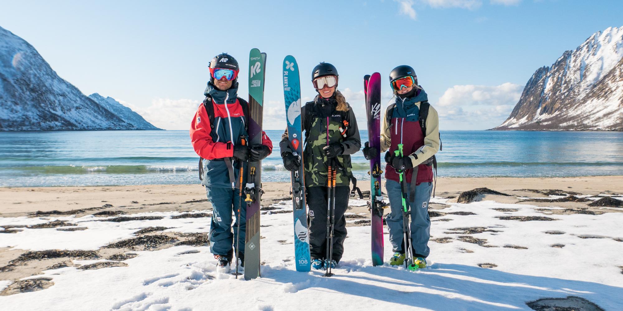 Three skiers just done mountain-to-beach-skiing in Senja
