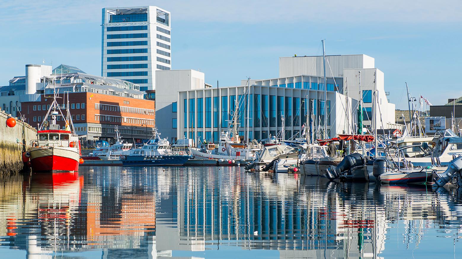View on the Stormen bibliotek from across the water of the harbour, Bodø, Northern Norway