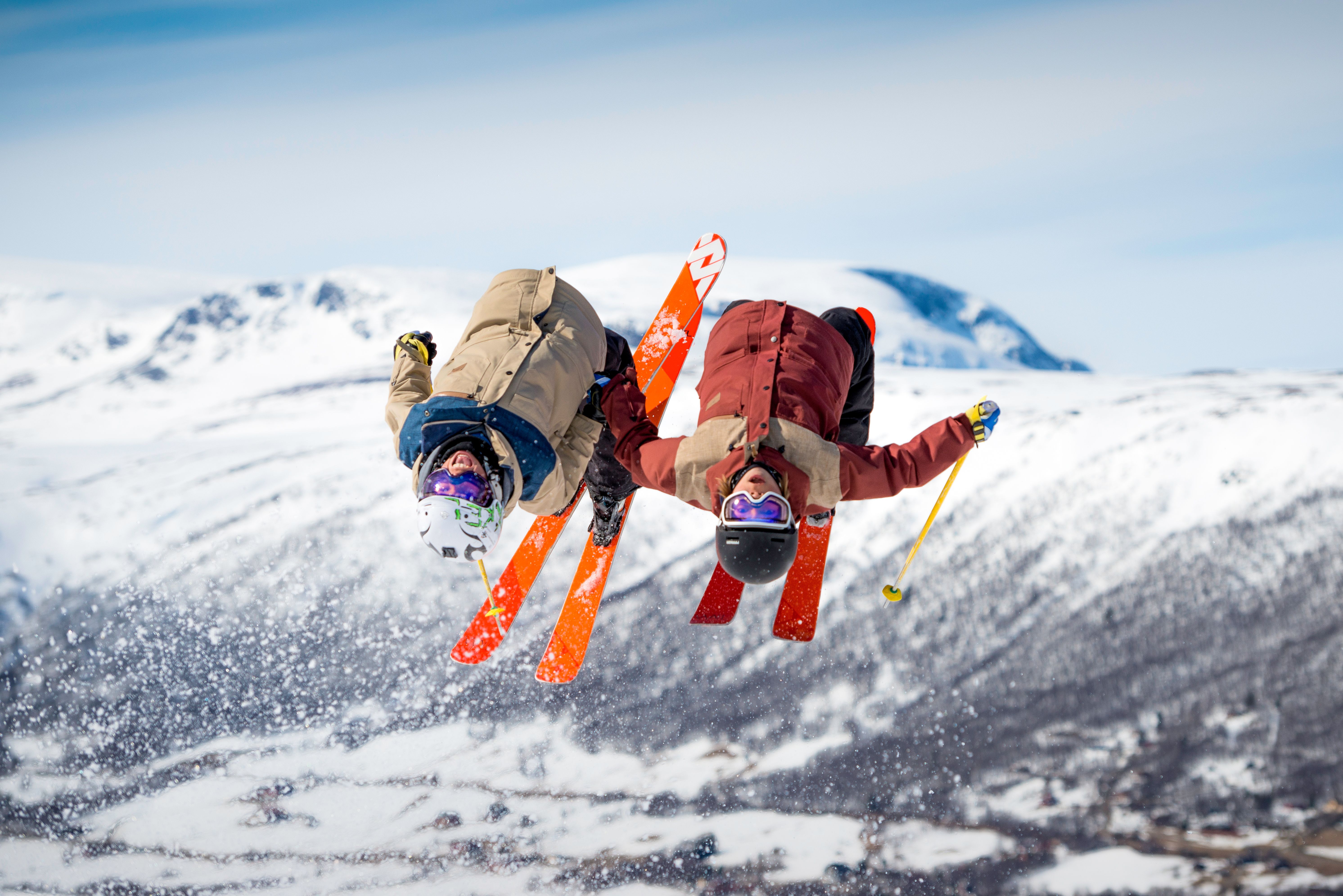 Two people doing back-flip on alpine skis at Geilo, Eastern Norway