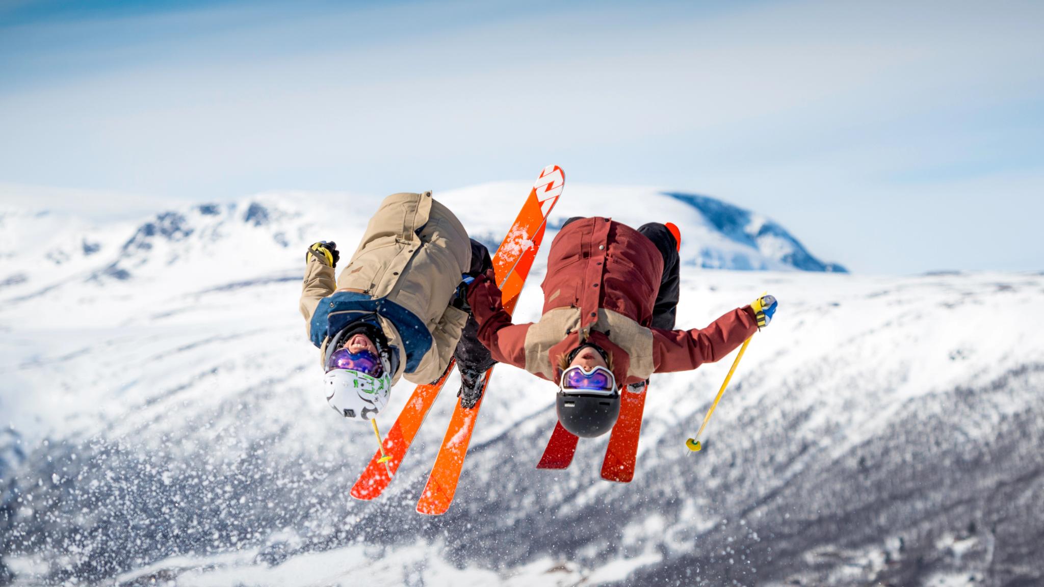 Two people doing back-flip on alpine skis at Geilo, Eastern Norway
