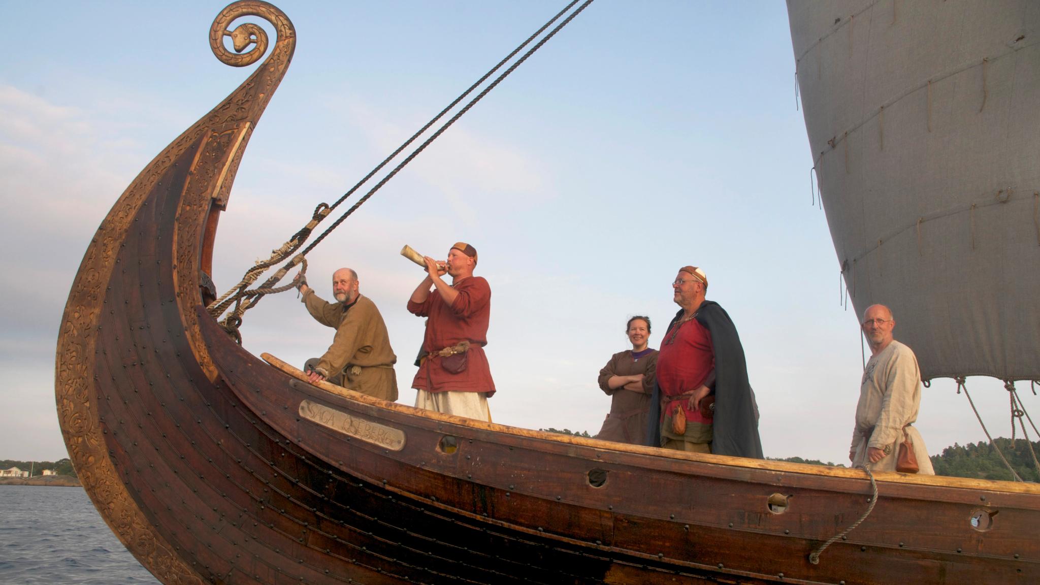 Five people in Viking outfits at the Saga Oseberg Viking ship in Tønsberg, Eastern Norway